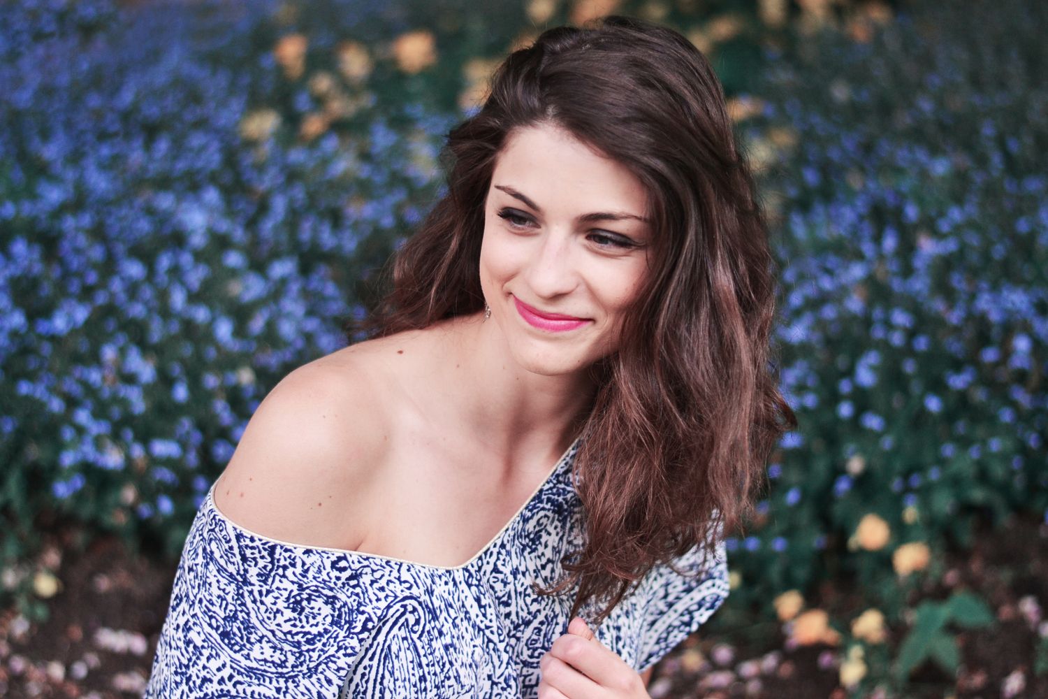 Portrait series with blue flowers creating a dreamy garden backdrop.