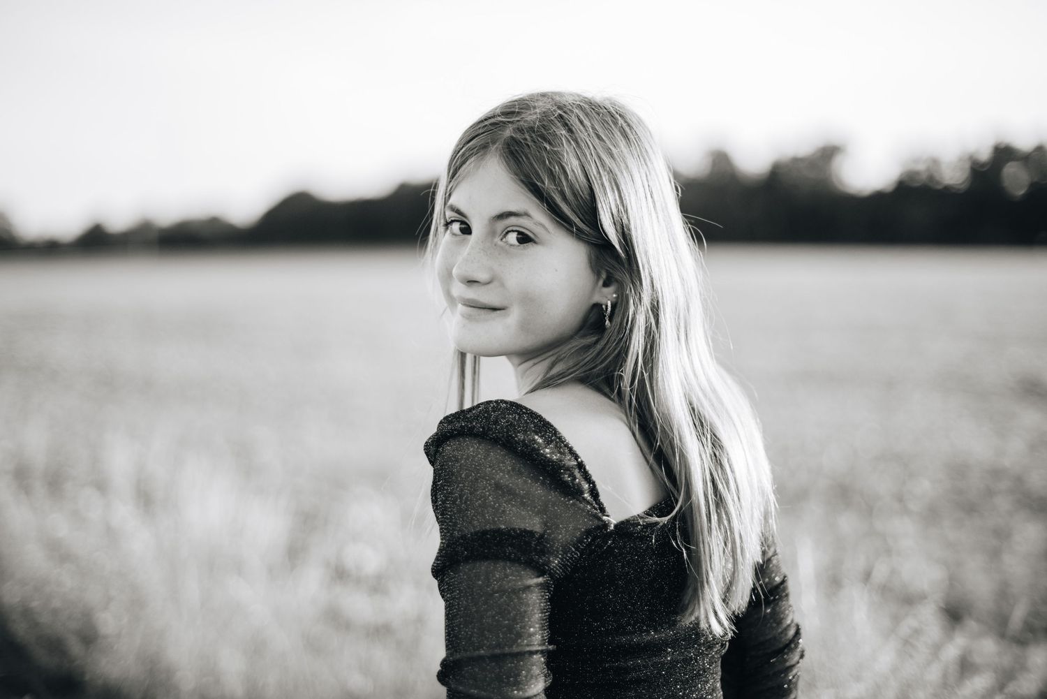 Artistic black and white portrait series in natural outdoor setting.
