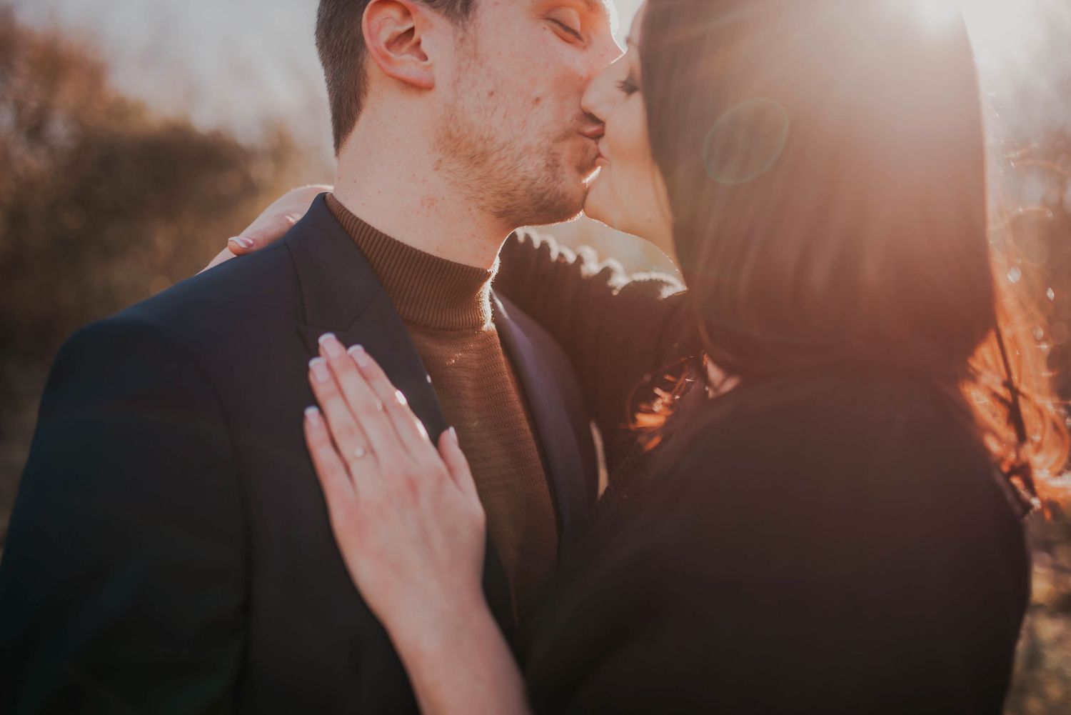 Golden sunlight streams through as a couple shares an intimate moment.