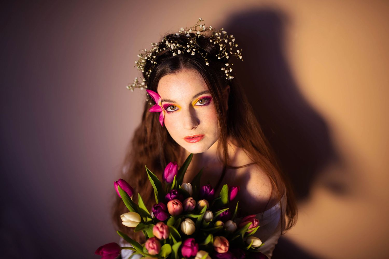 Artistic portrait series with floral elements and dramatic lighting.