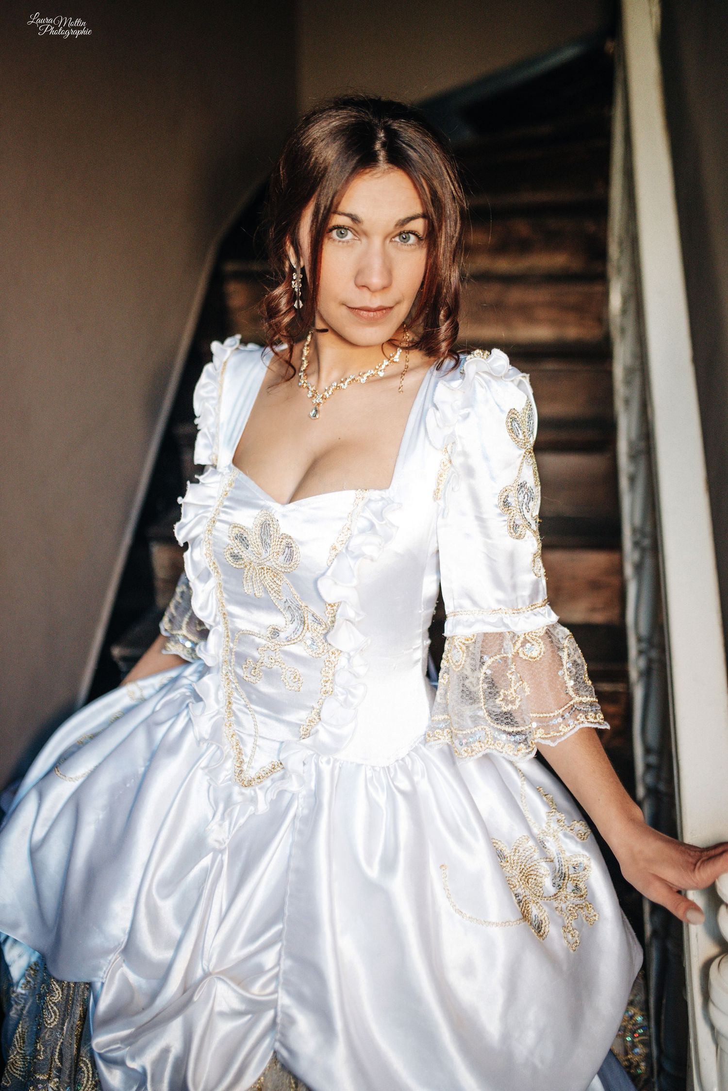 White Regency-era dress with delicate lace details and puffy sleeves shown in multiple angles.