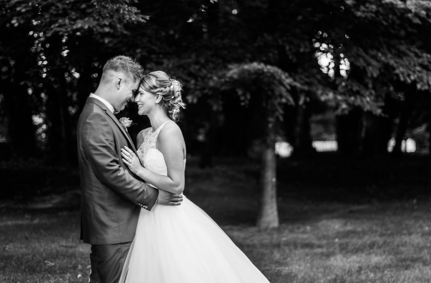 Black and white romantic wedding photos captured in an outdoor garden setting.