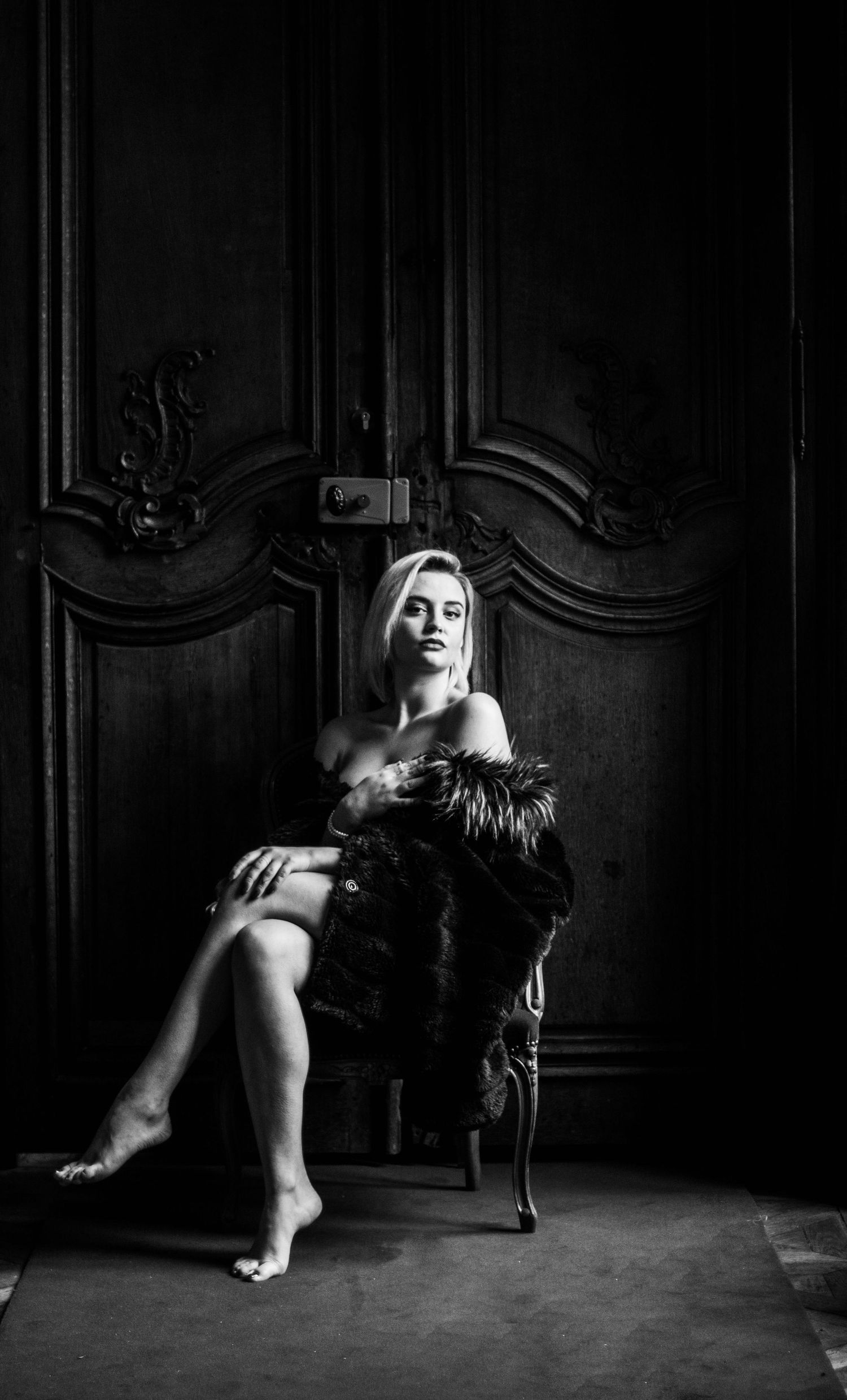A dramatic black and white photo sequence showing a figure in motion against an ornate wall with dark shadows.