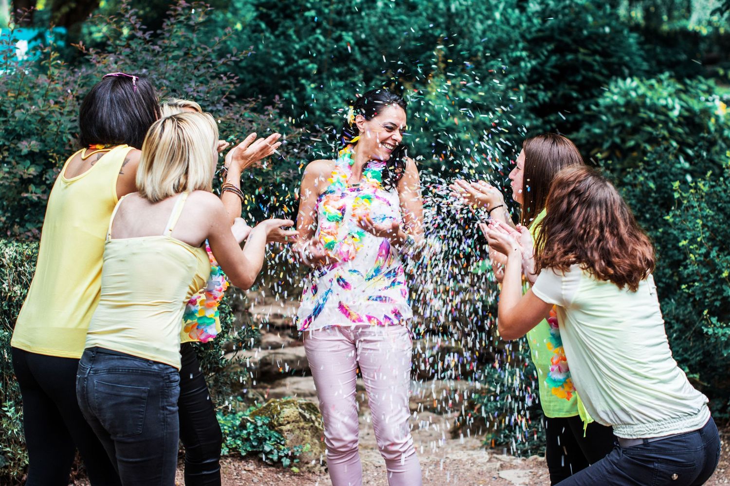 Group enjoying a fun outdoor photoshoot in casual summer clothing.