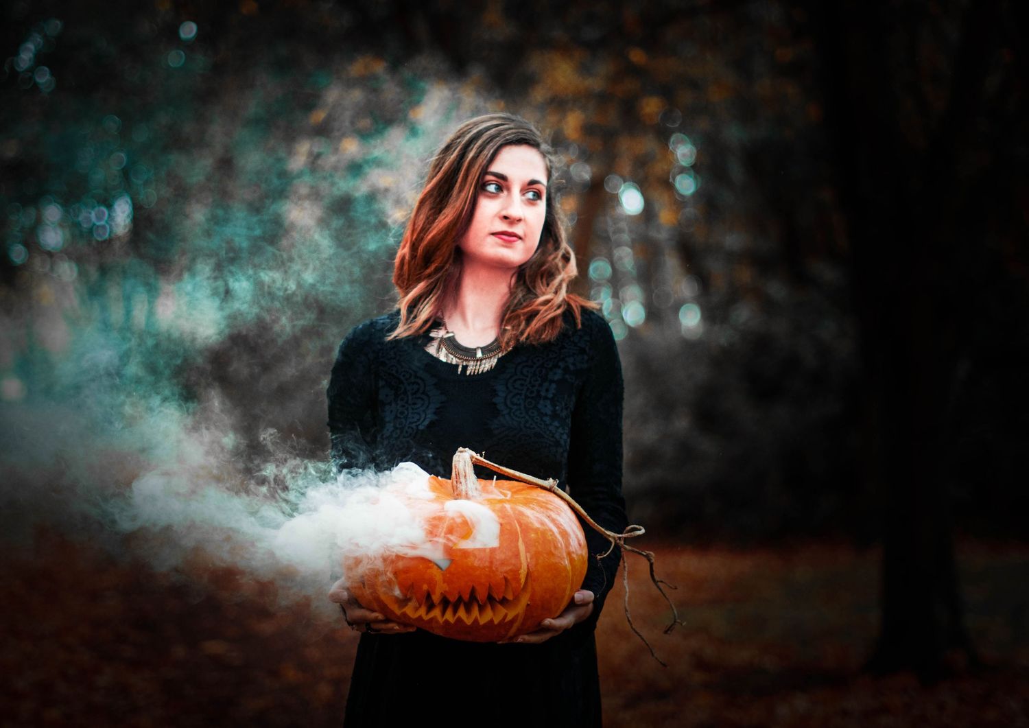 Atmospheric Halloween scene with glowing jack o'lantern pumpkin and smoke effects.