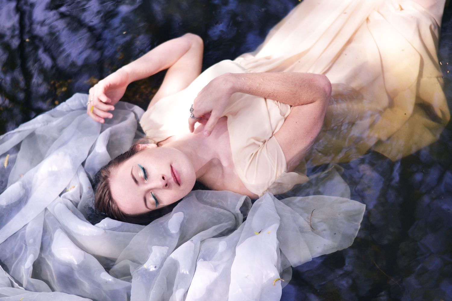 Ethereal portrait series with soft lighting and delicate poses.
