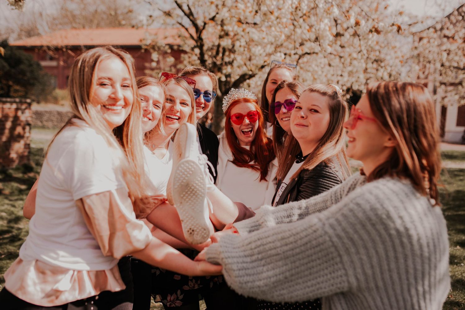 Group of friends sharing joyful moments together in warm autumn lighting.