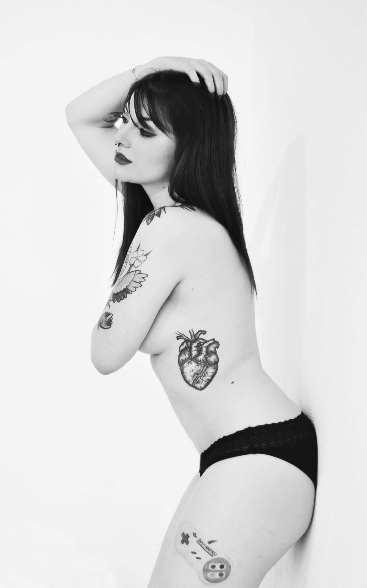 Black and white artistic portrait series showcasing tattoo art.
