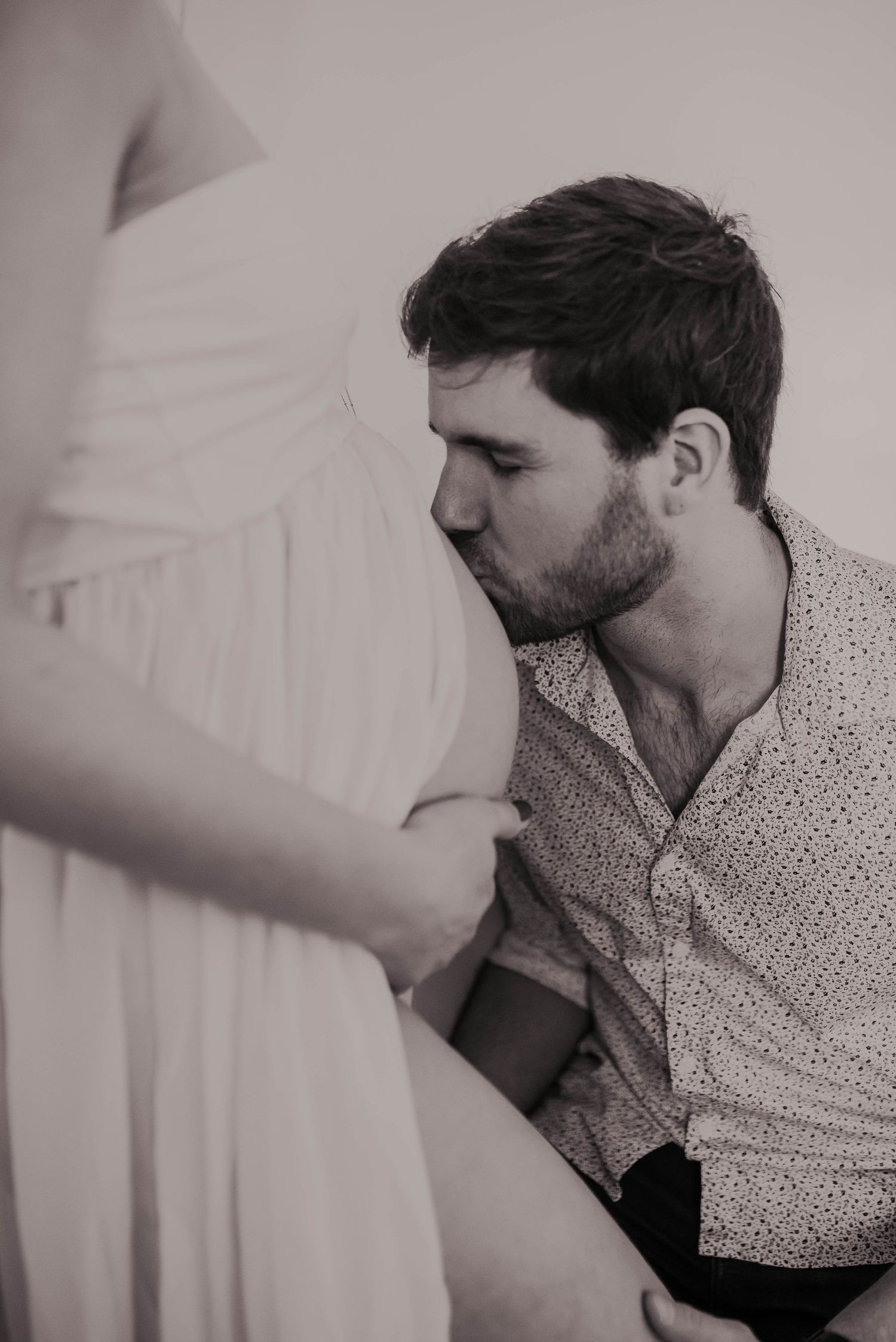 Intimate black and white photo series showing tender moments and gentle touches.