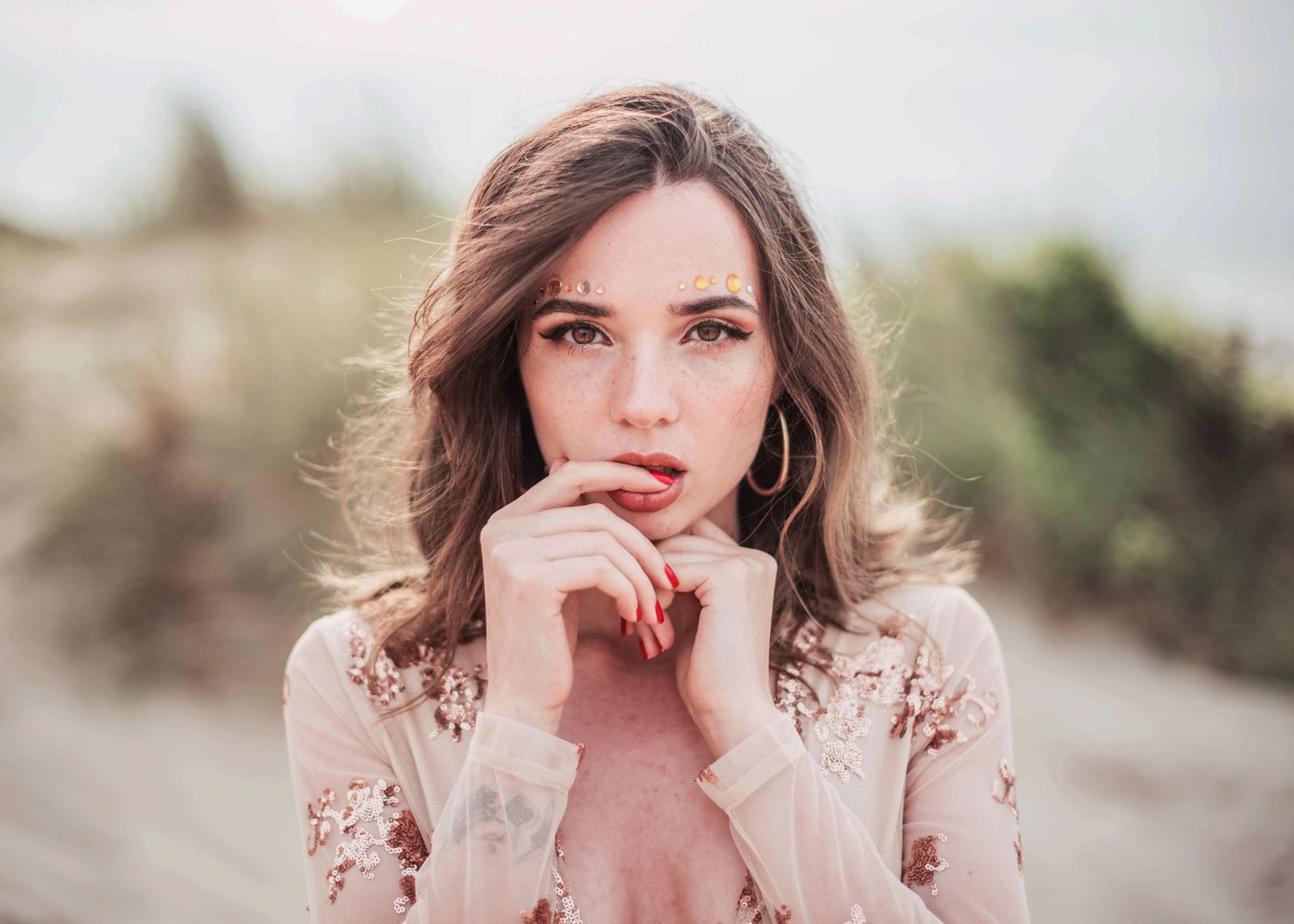 Soft portrait in muted tones featuring delicate lace details and natural lighting in an outdoor setting.