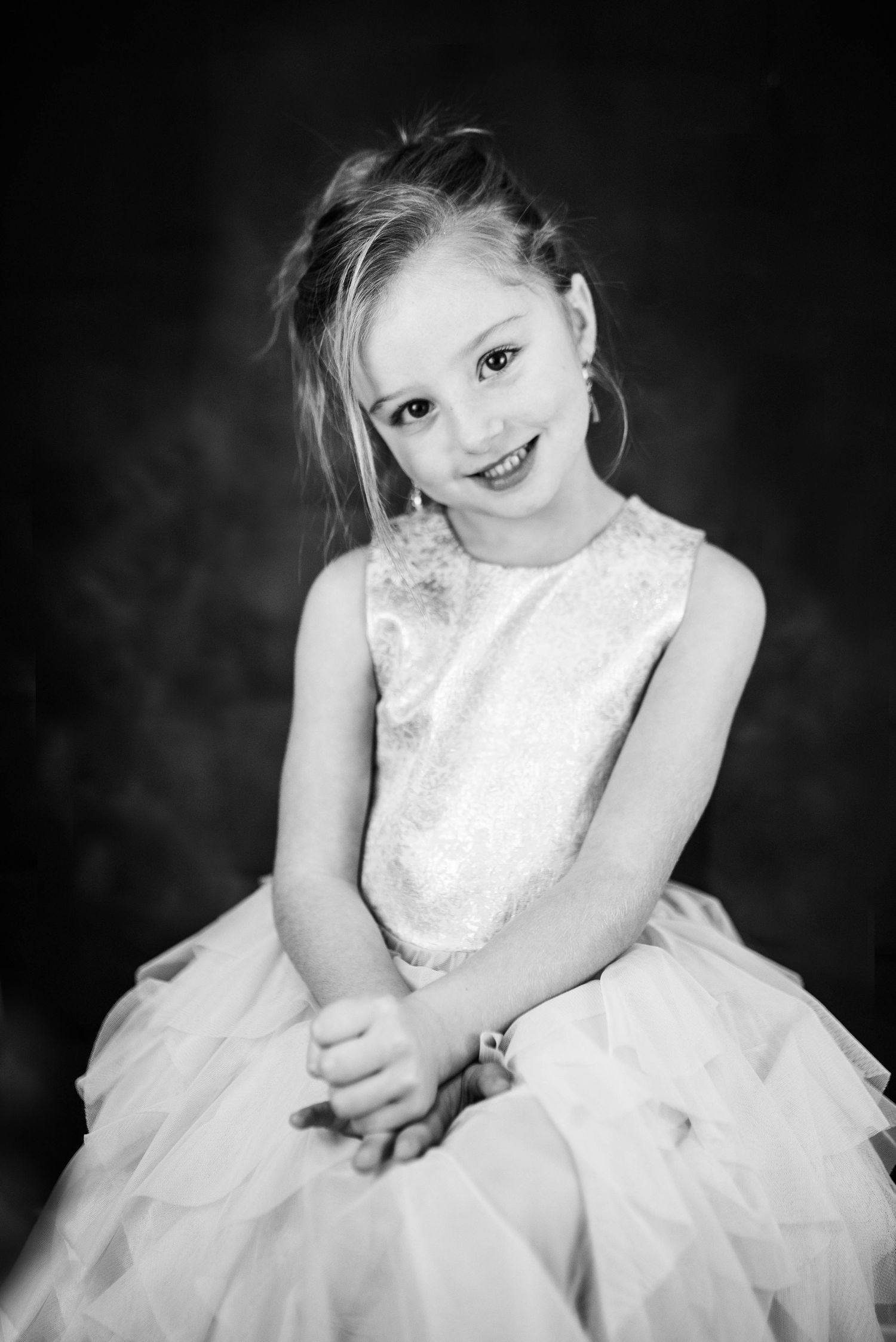 Black and white portrait series featuring white lace dress against dark background.