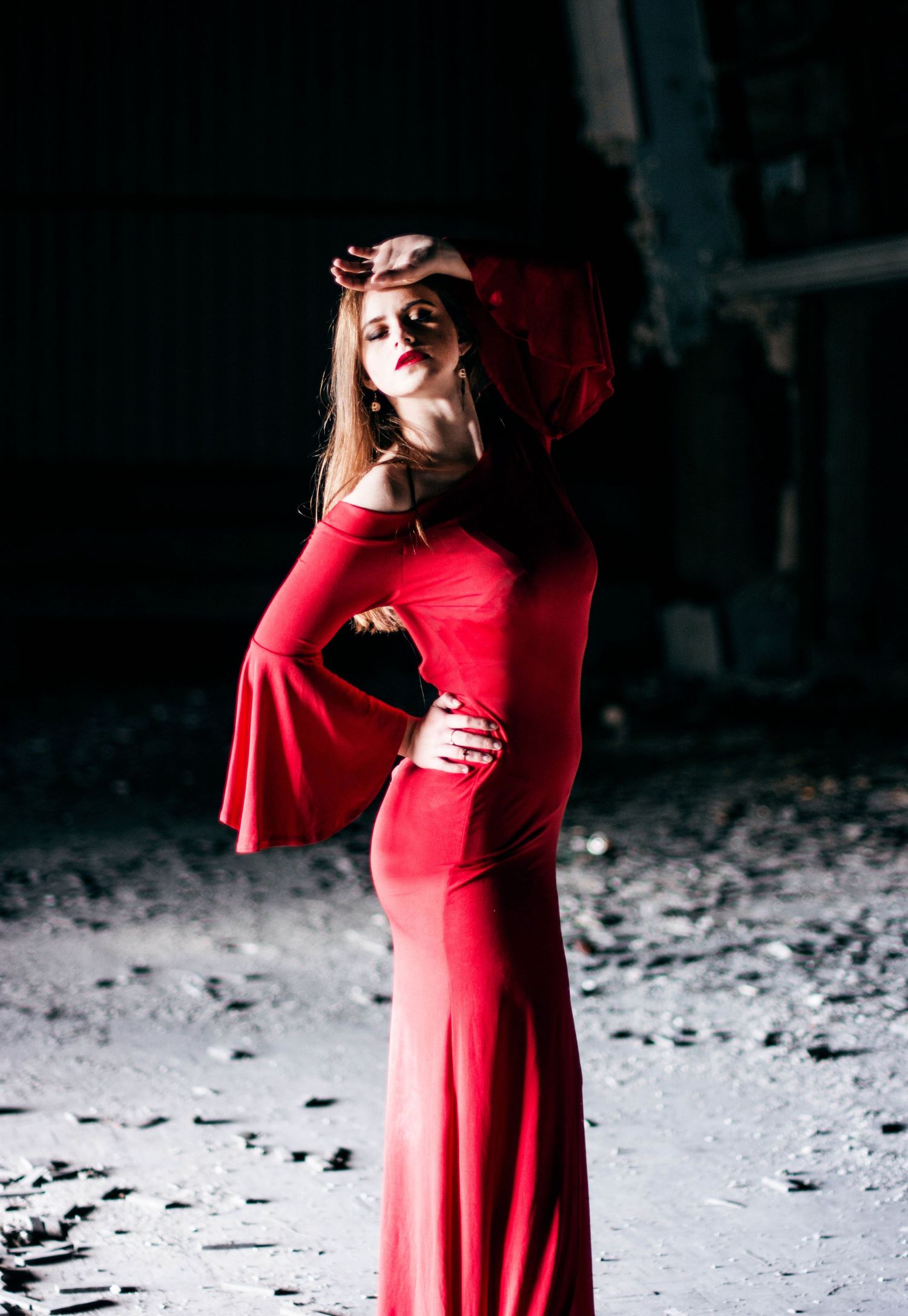Dramatic fashion series featuring a flowing red dress against a dark background with dynamic movement.