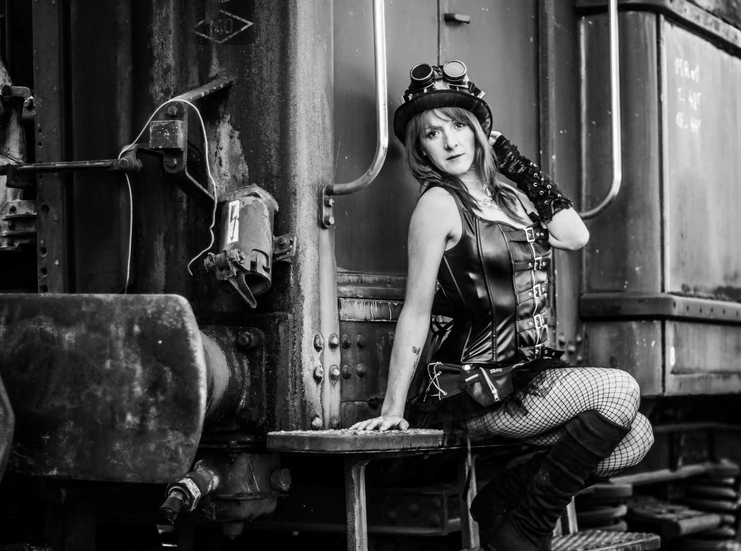 Dark industrial photoshoot with steampunk aesthetic in black and white.