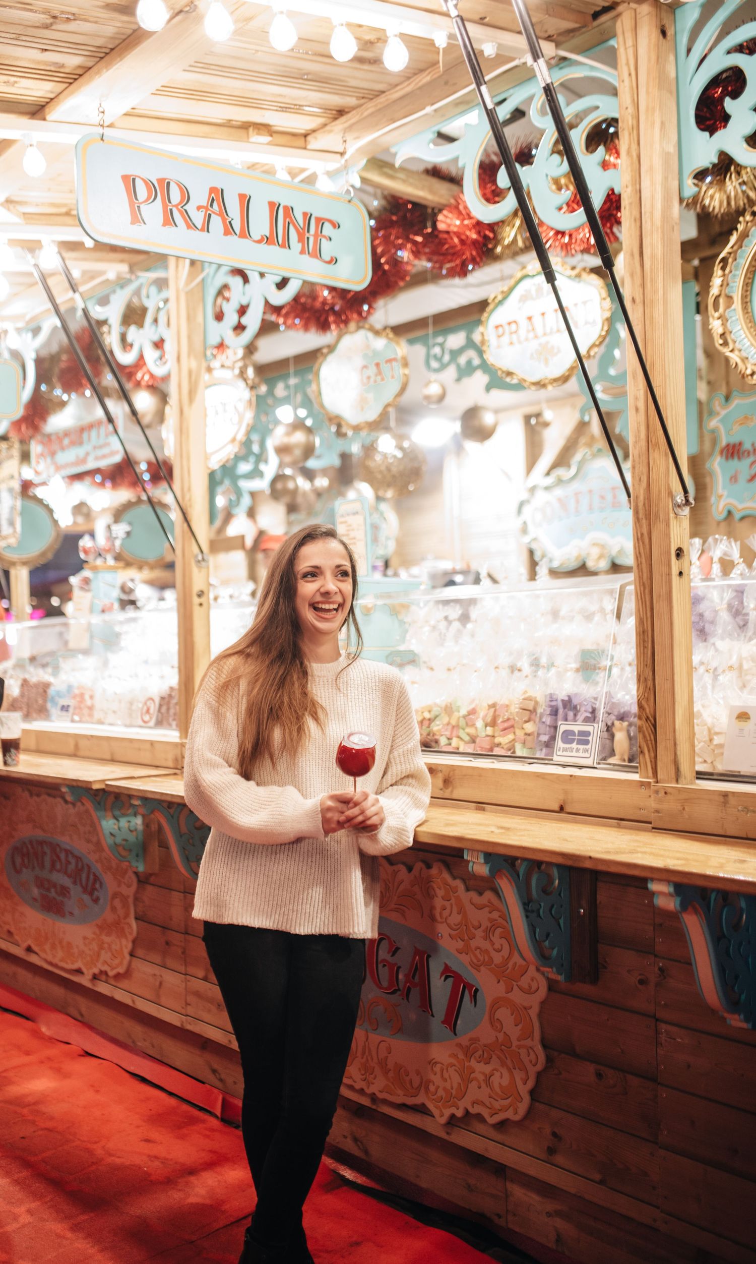 Festive carnival scene with wooden panels and decorative lighting creating a nostalgic atmosphere.