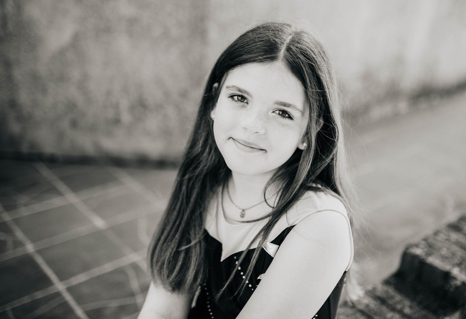 Black and white portrait series showing joyful expressions in natural light.
