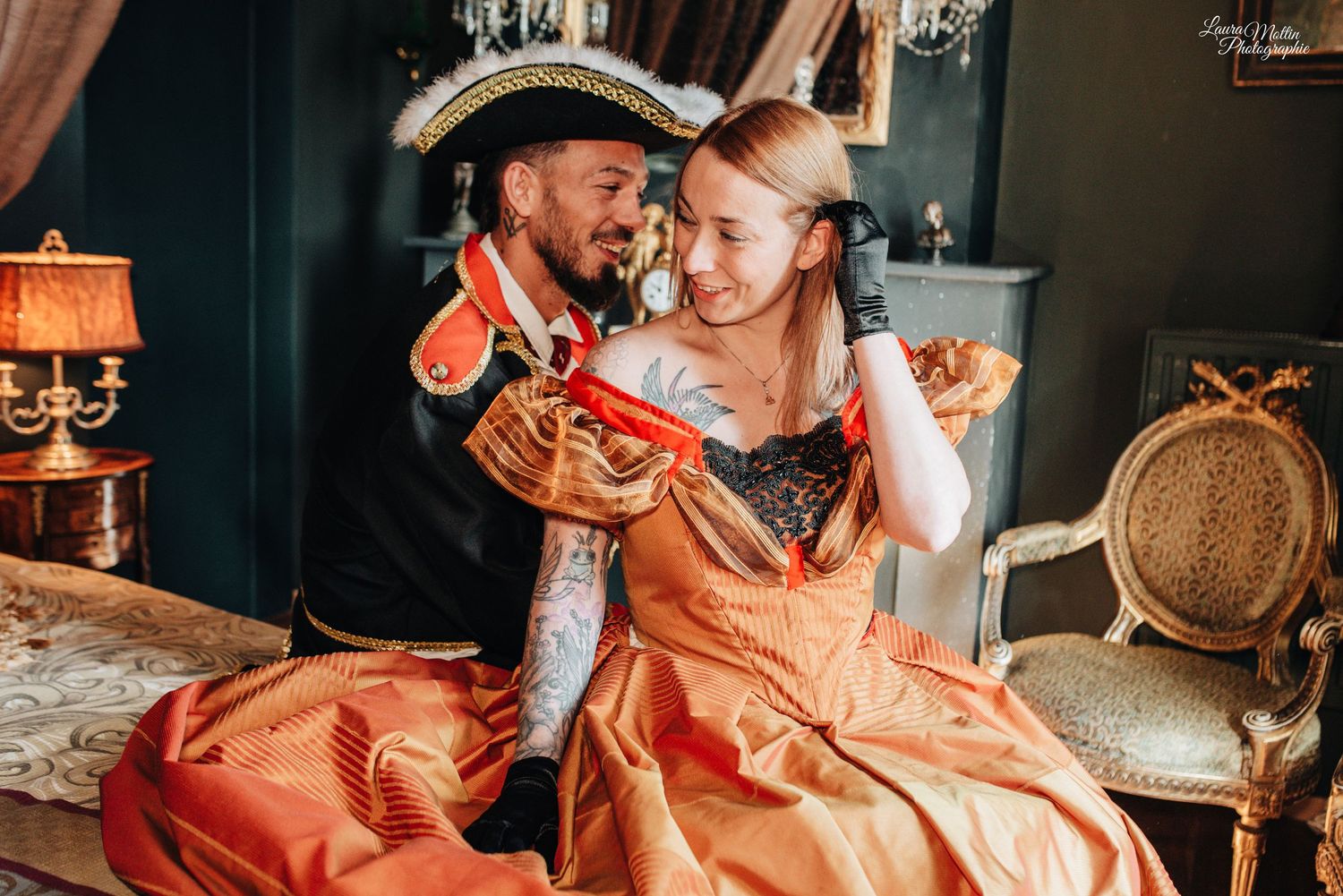 Romantic vintage-themed photoshoot with period costumes in warm lighting.