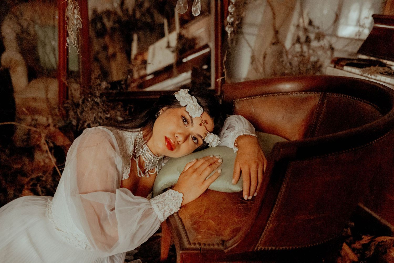 A romantic couple shares intimate moments in a dimly lit setting with vintage styling.