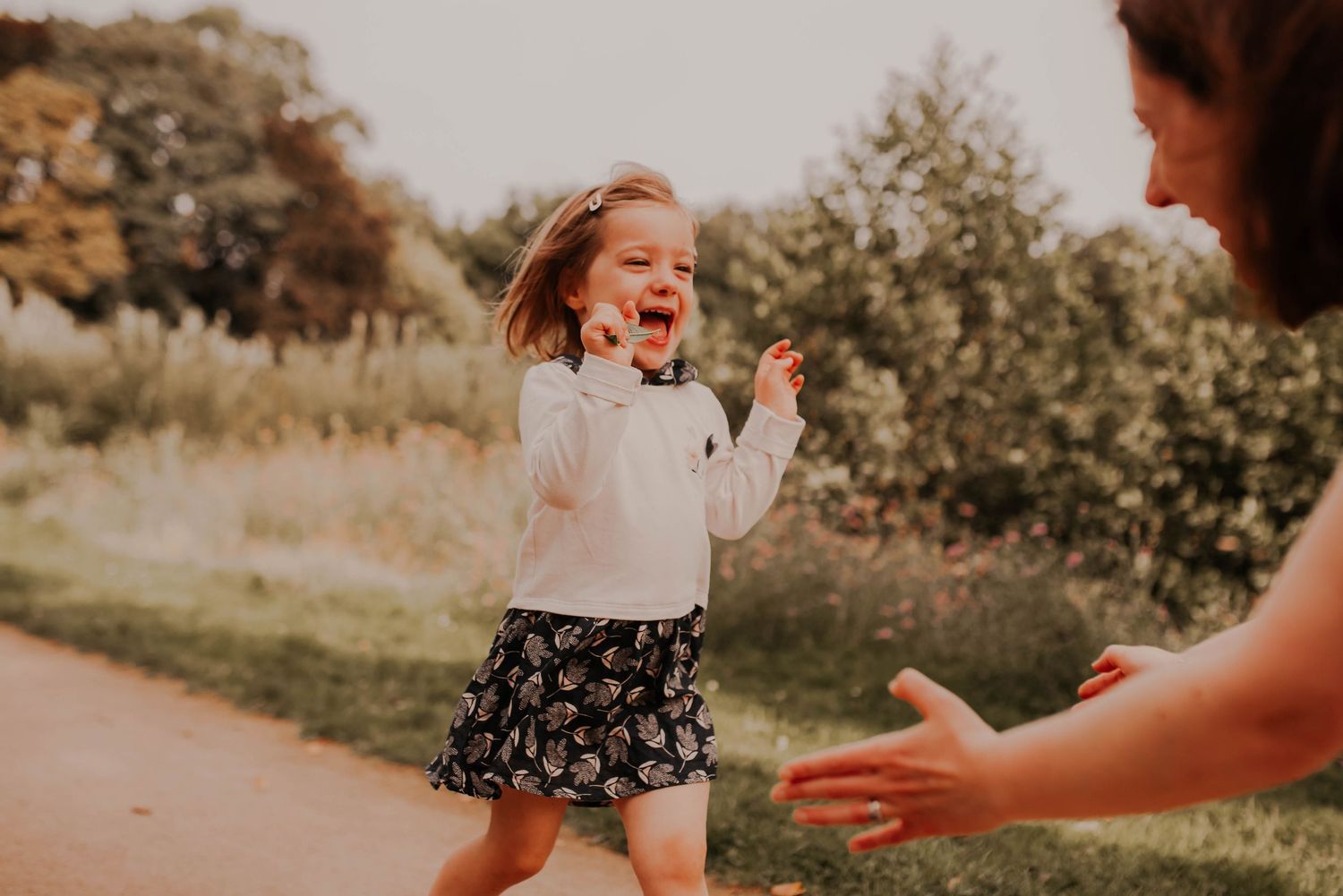 Playful moments captured in a sunny outdoor setting with natural backdrops.