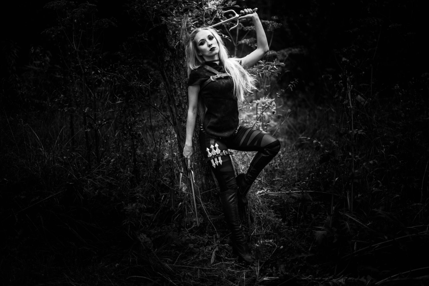Moody black and white photographs capturing mysterious forest scenes.