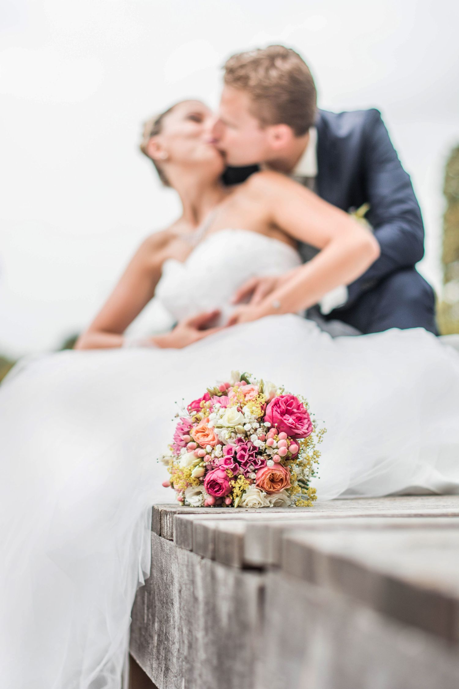 Beautiful pink and peach wedding bouquet with blurred romantic background.