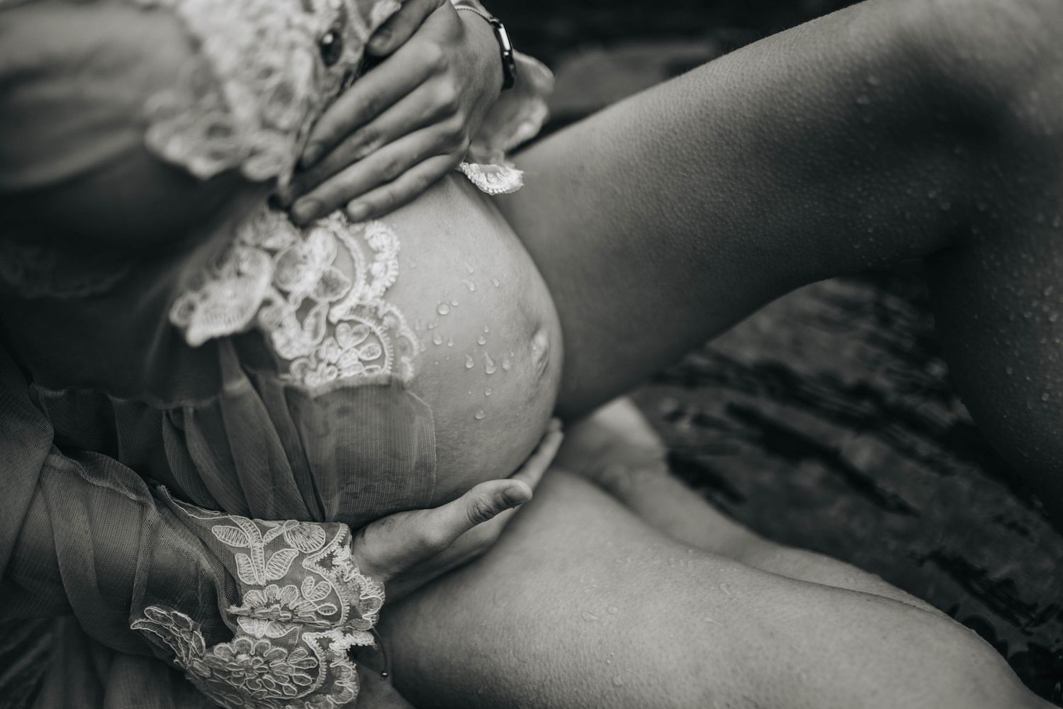 Black and white artistic maternity photos showing close-up details of lace and fabric.