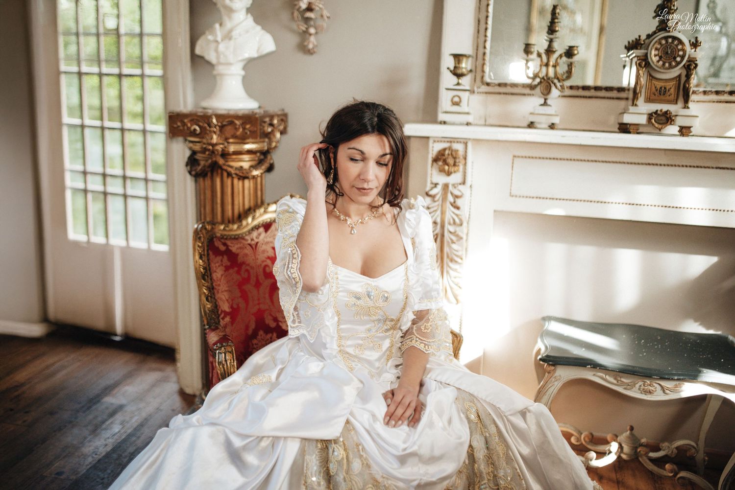 Elegant bridal portrait in a vintage room with ornate furniture and natural lighting.