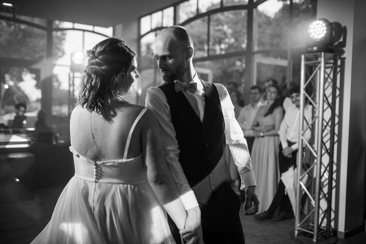An intimate black and white dance moment captured during a wedding reception.