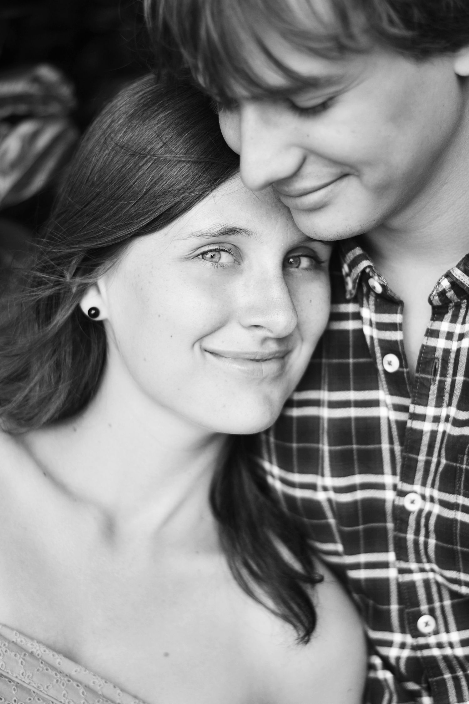 Close-up black and white portrait of intimate moment between couple.