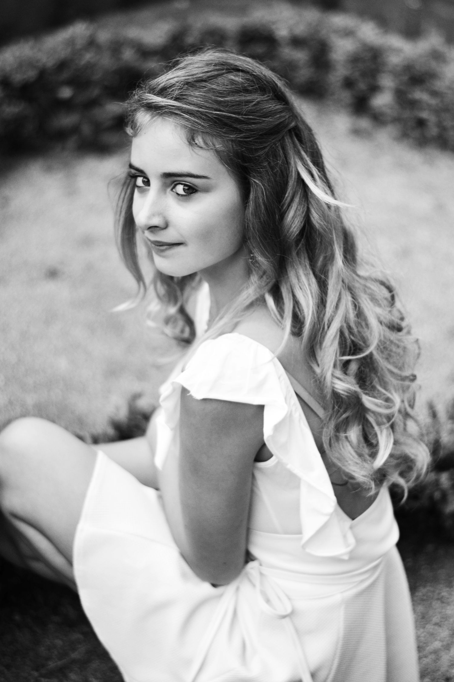 Black and white portrait series featuring a white ruffled top.