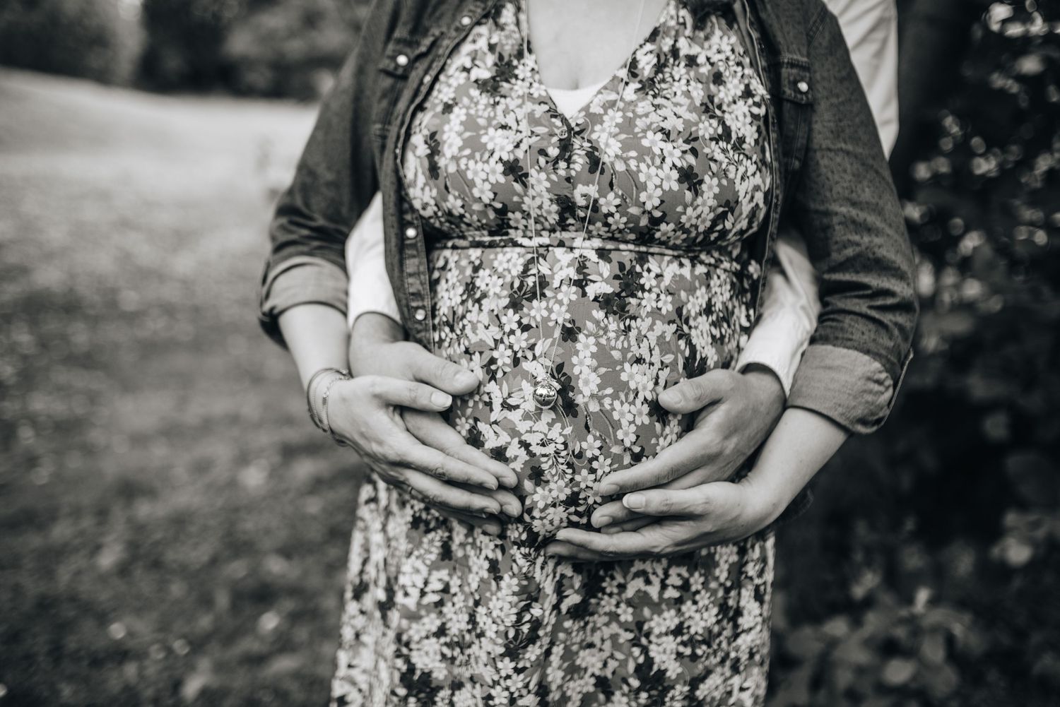 Series of maternity photos showing growing baby bump in floral dress against natural backdrop.