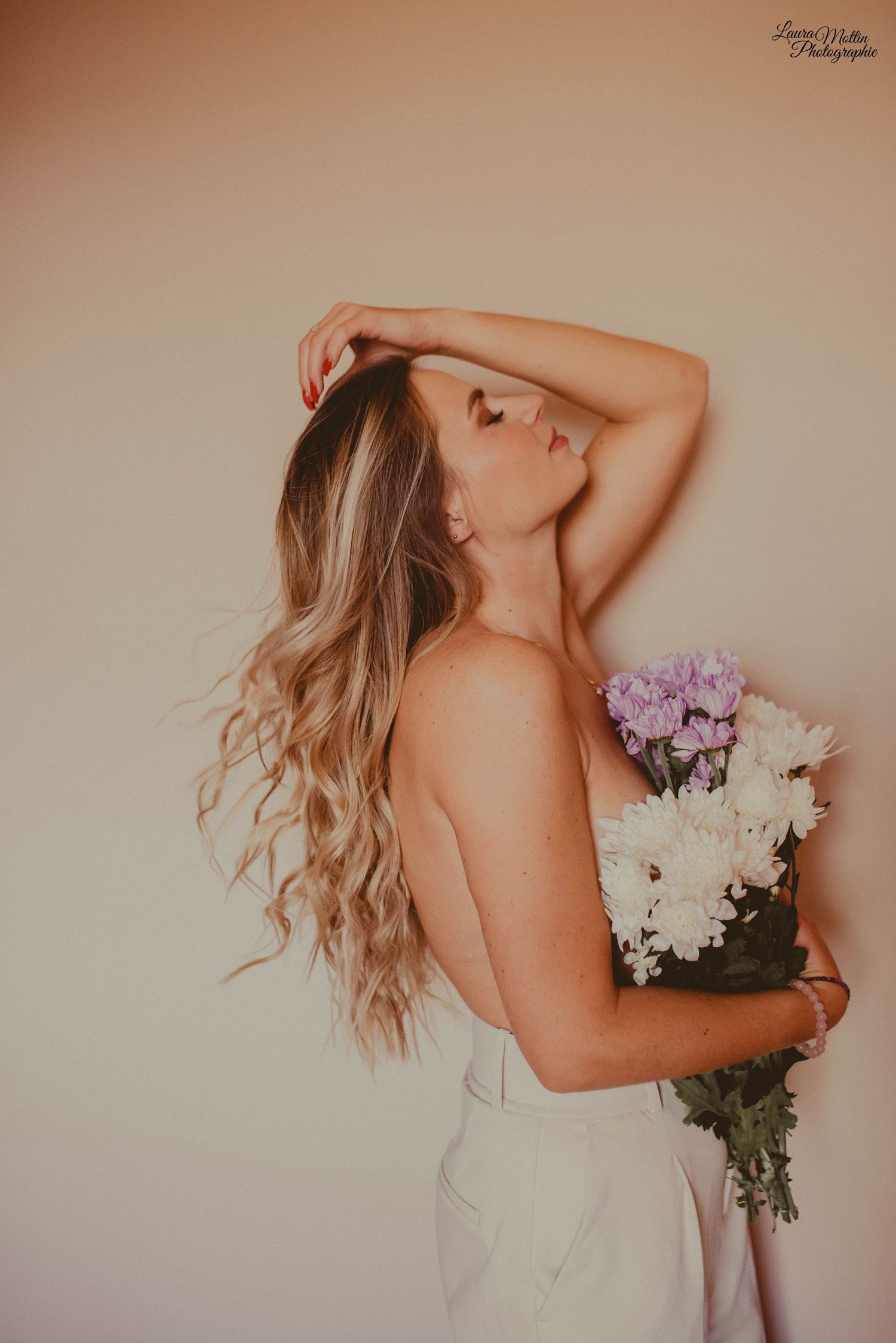 Ethereal portrait series with white and purple flowers against neutral background.