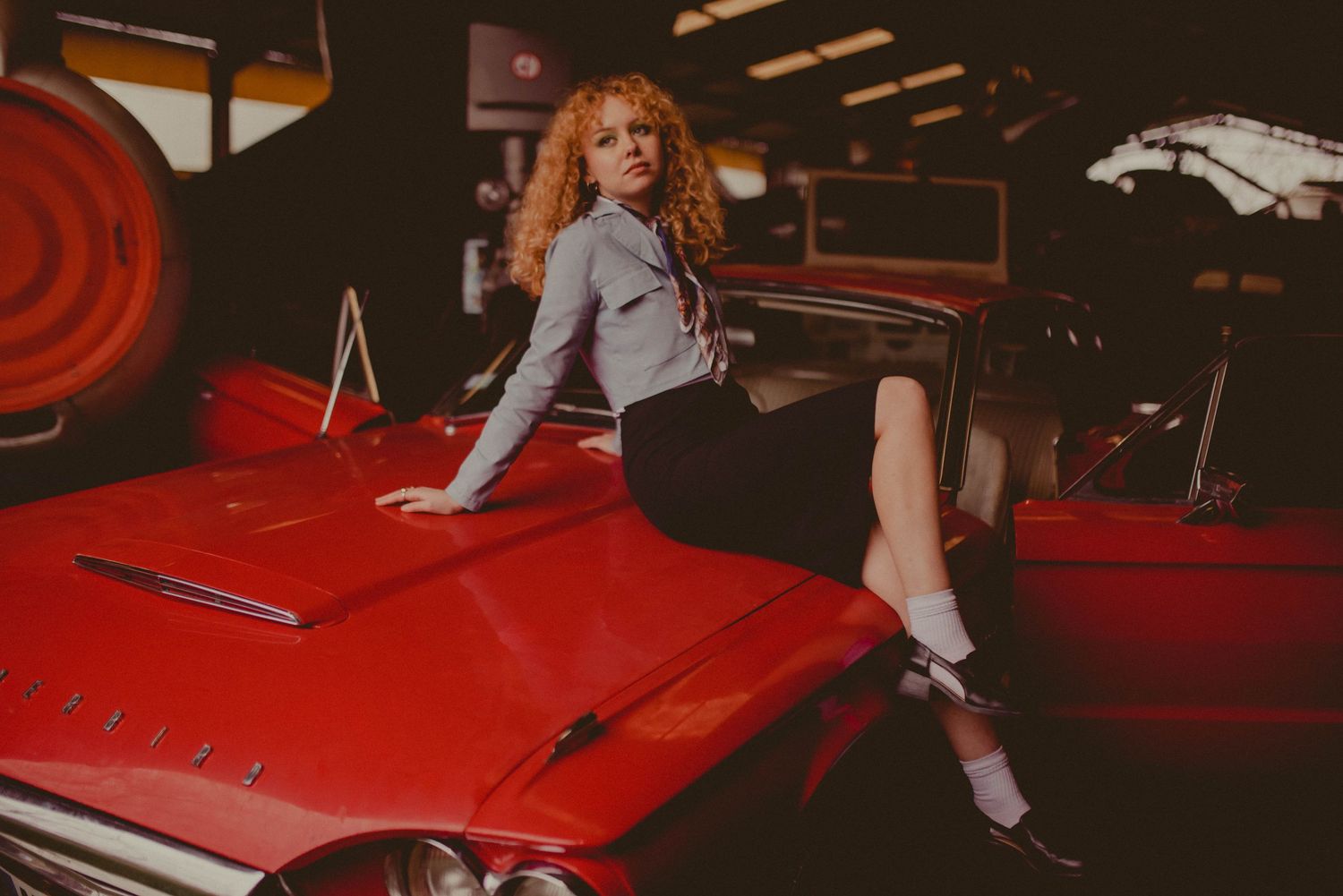 A vintage red car photographed in moody, atmospheric lighting.