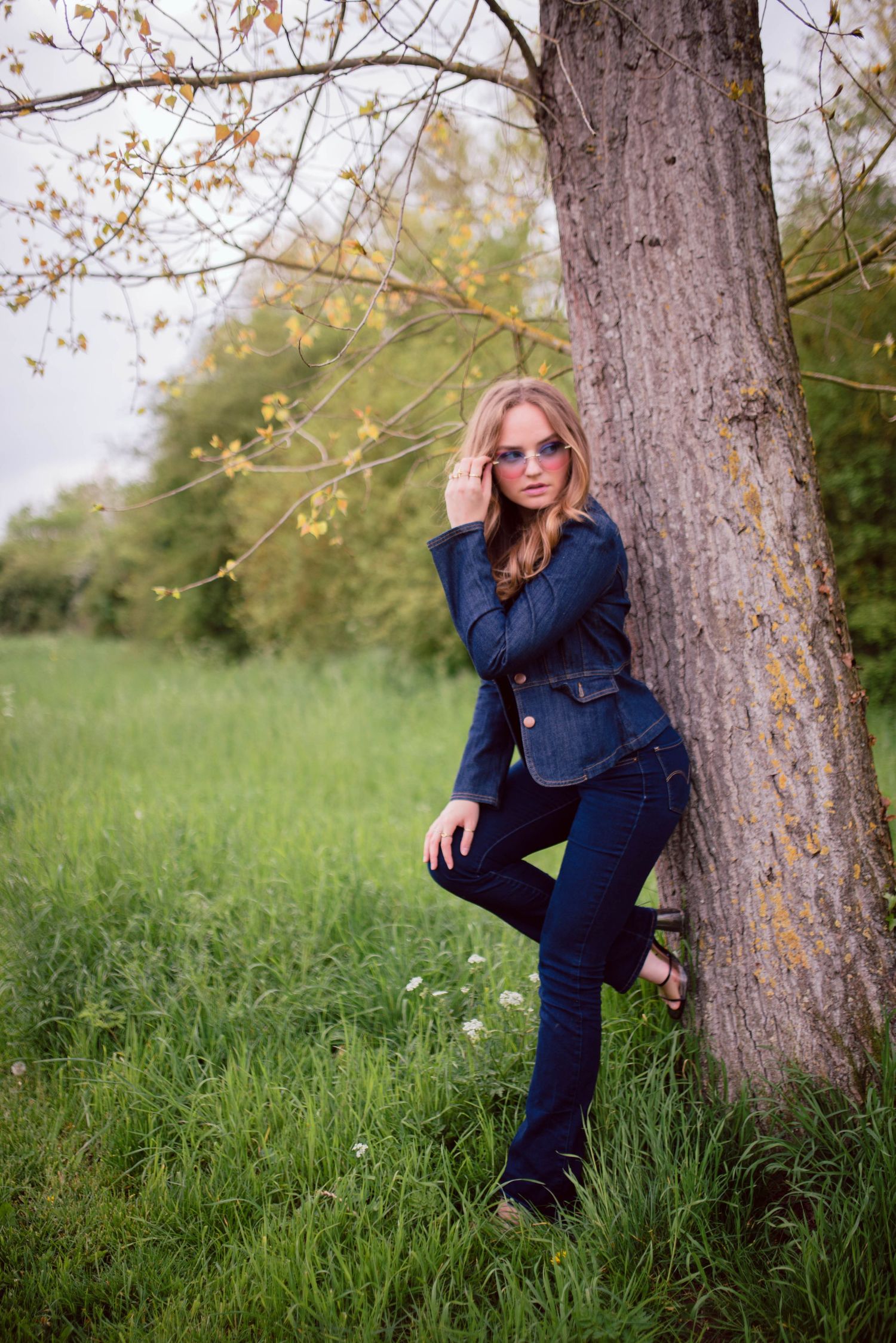 Artistic portraits taken under a large tree in a grassy field.