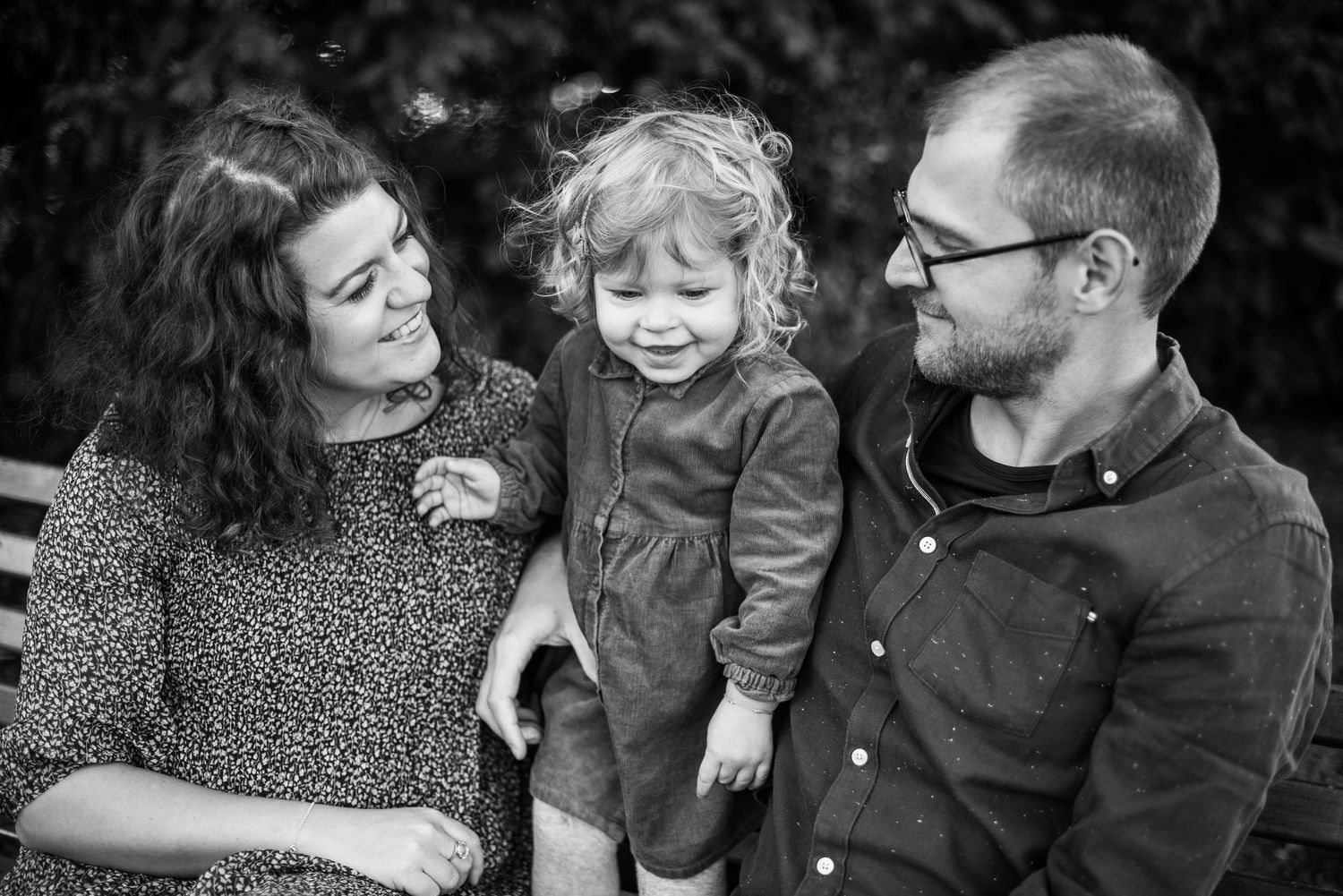 Candid family moments captured during an outdoor photo session.