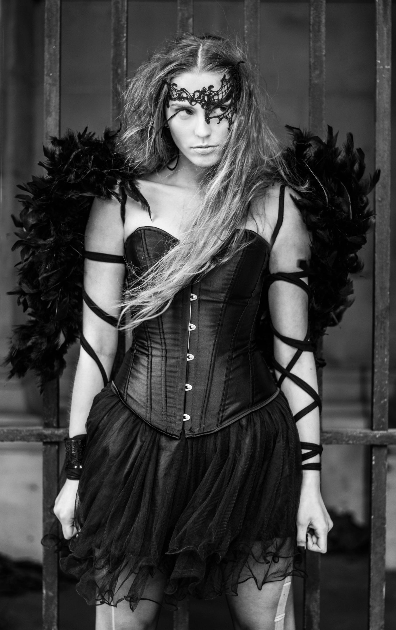Gothic fashion series featuring black corset dress and feather accessories.