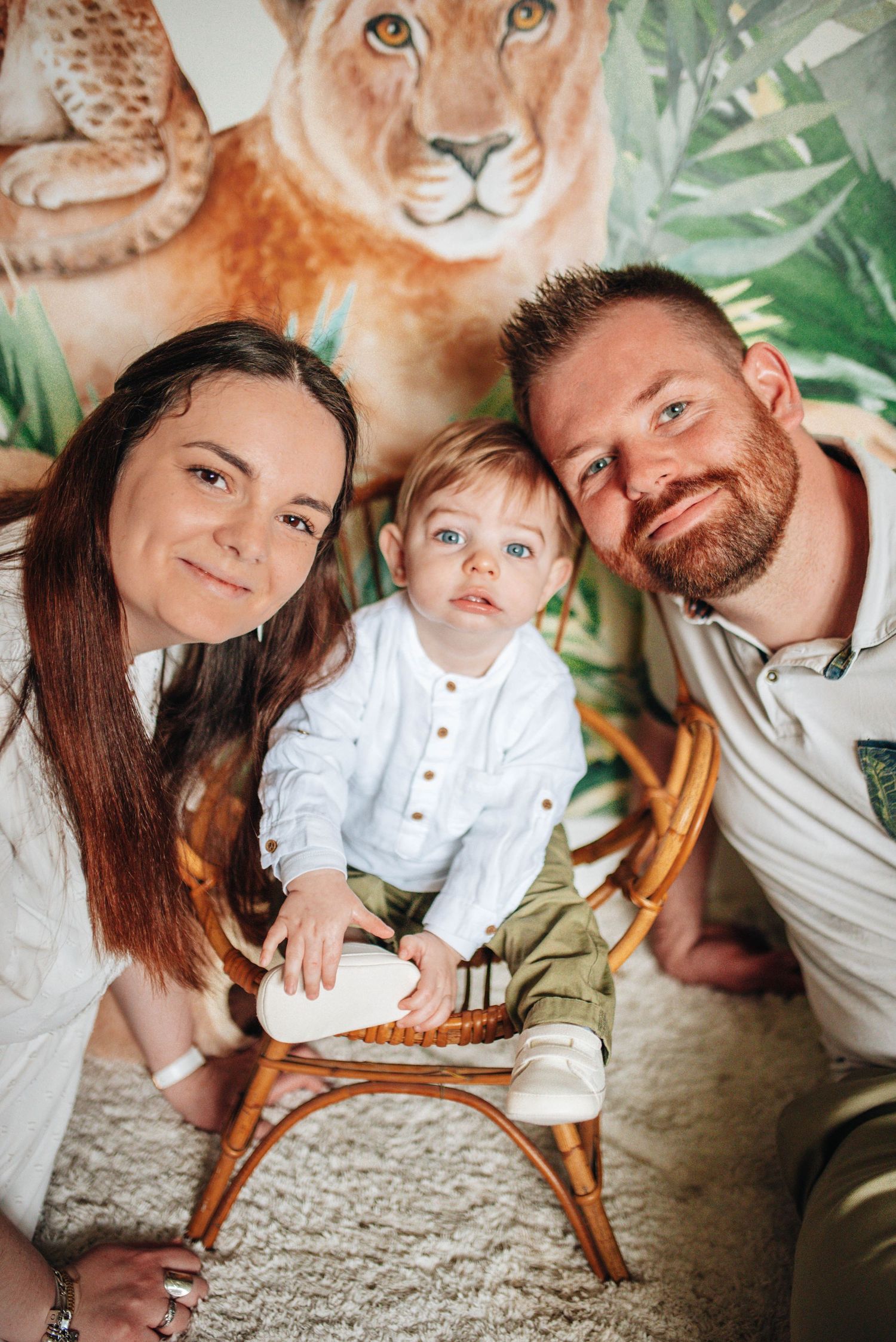 Family portrait session featuring a lion themed nursery backdrop with jungle elements.