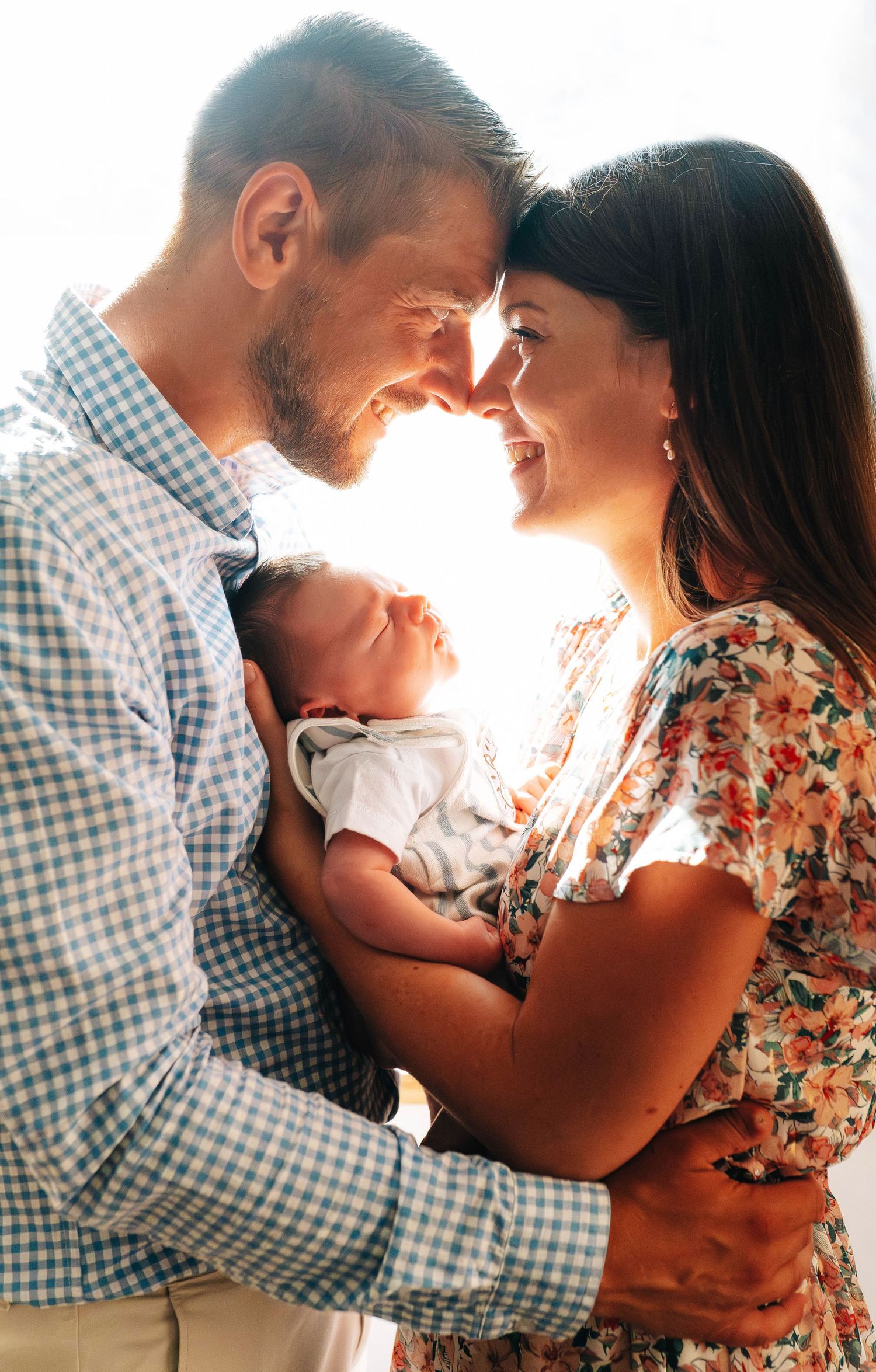 Family sharing intimate moment in warm sunlit room.
