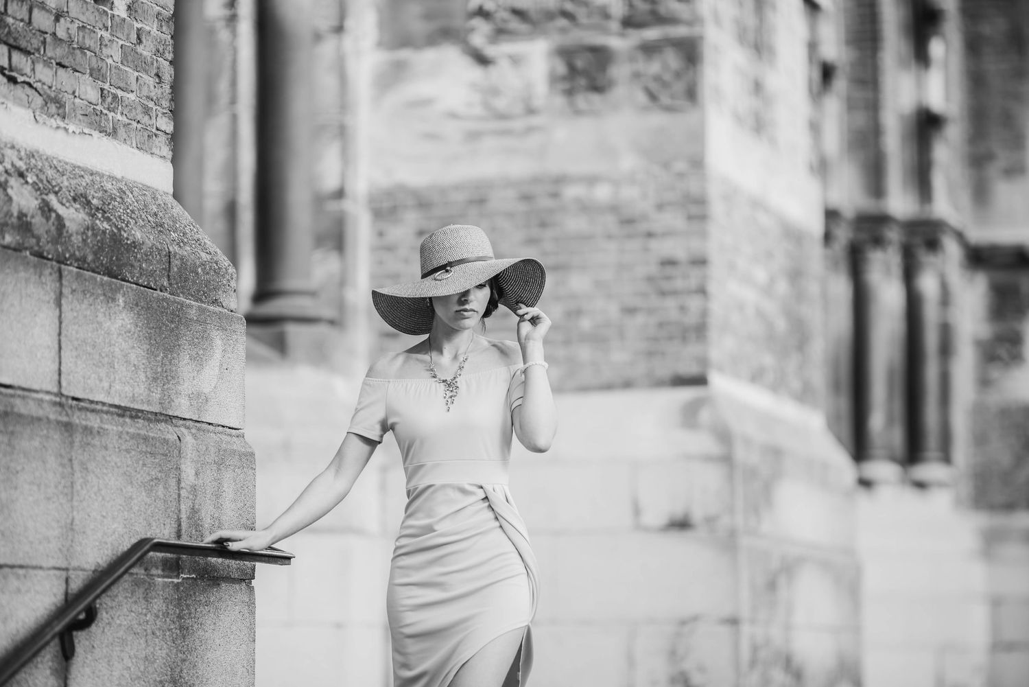 Black and white architectural portrait with vintage aesthetic and stone building elements.