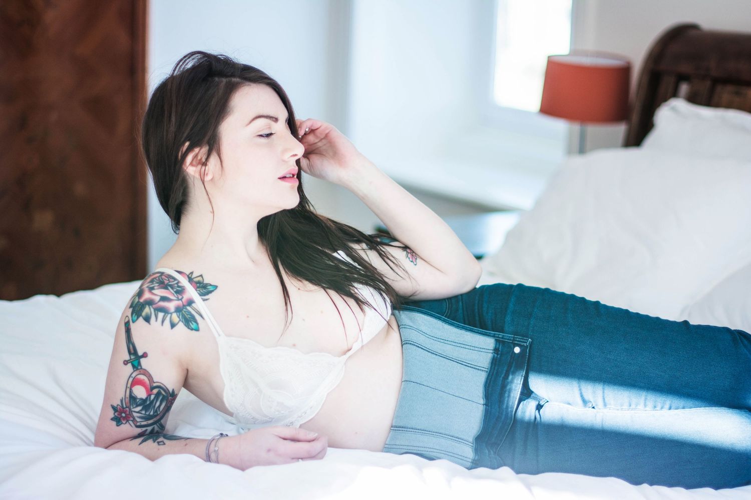 Intimate bedroom photo series with soft natural window lighting.