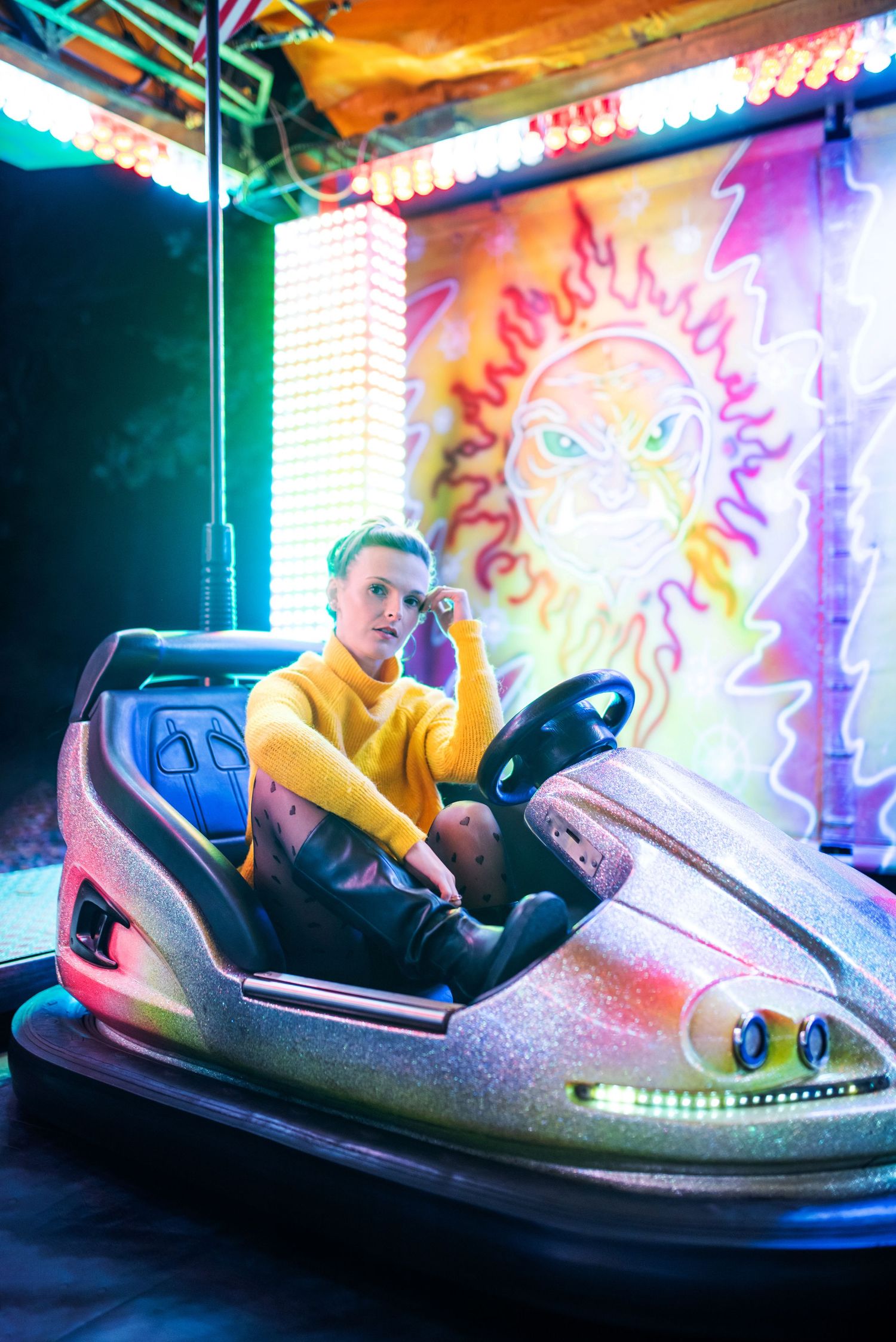 Colorful bumper car ride scene with neon lights and retro amusement park atmosphere.