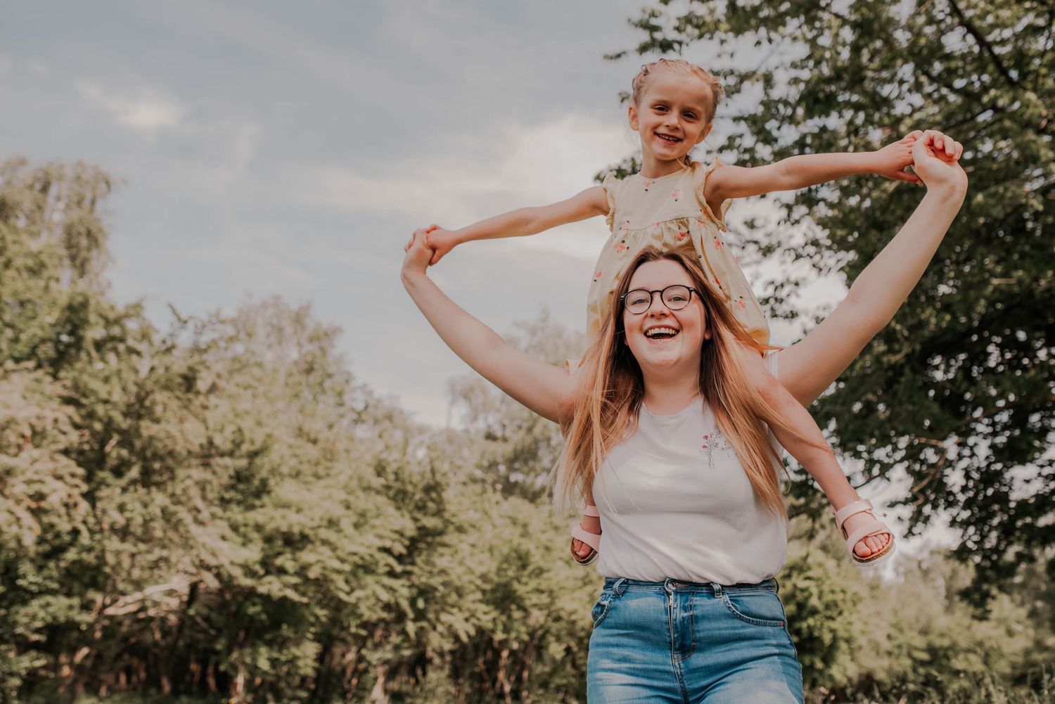 Playful family moments captured outdoors on a sunny day.