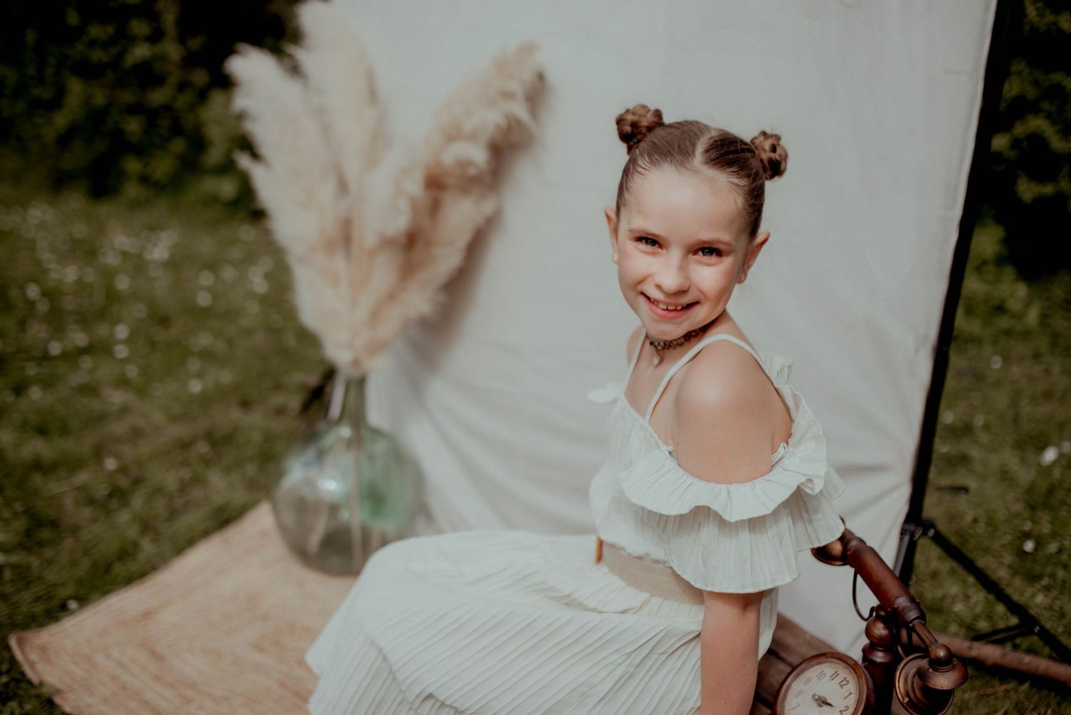 Dreamy outdoor photo series with white dresses and vintage-inspired styling against a light backdrop.