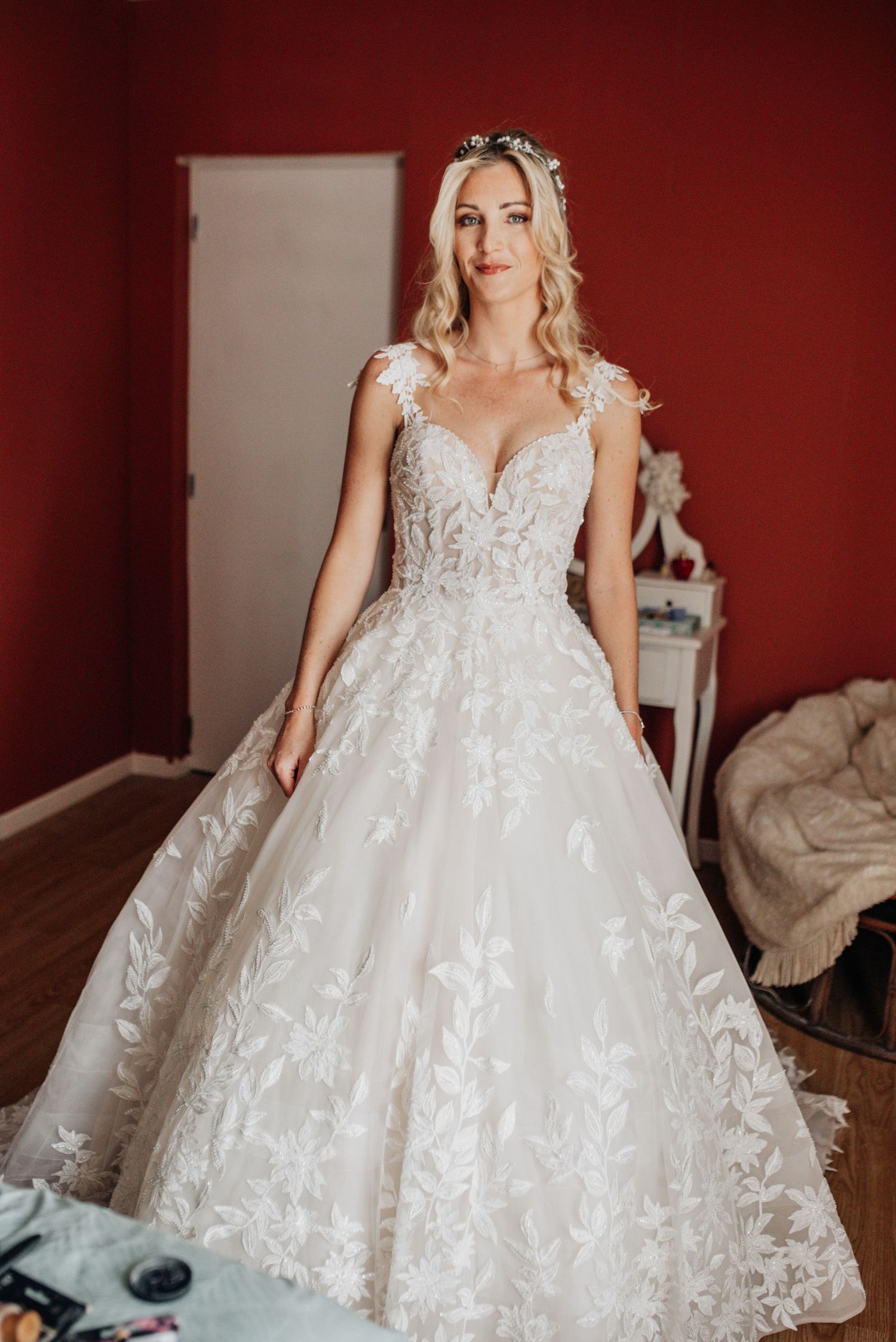 A stunning lace wedding gown with floral appliques and a full princess skirt.