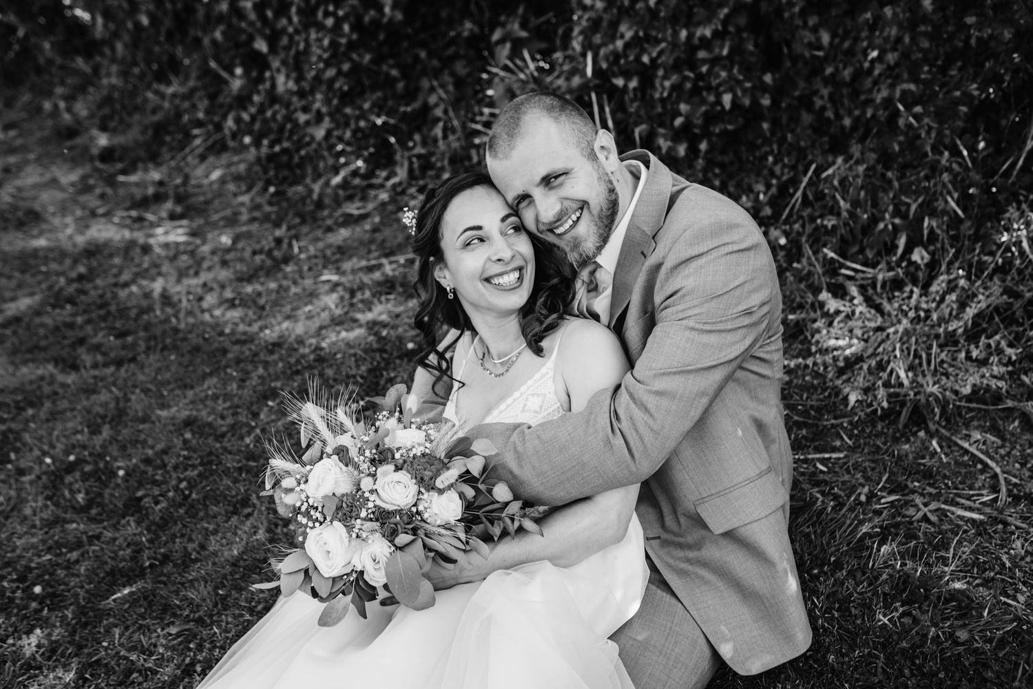 Black and white wedding portraits captured in an outdoor garden setting.