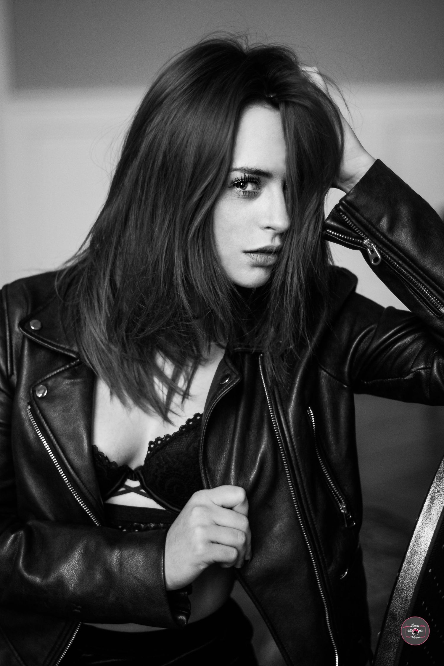 Dramatic black and white portraits with leather jacket in moody lighting.