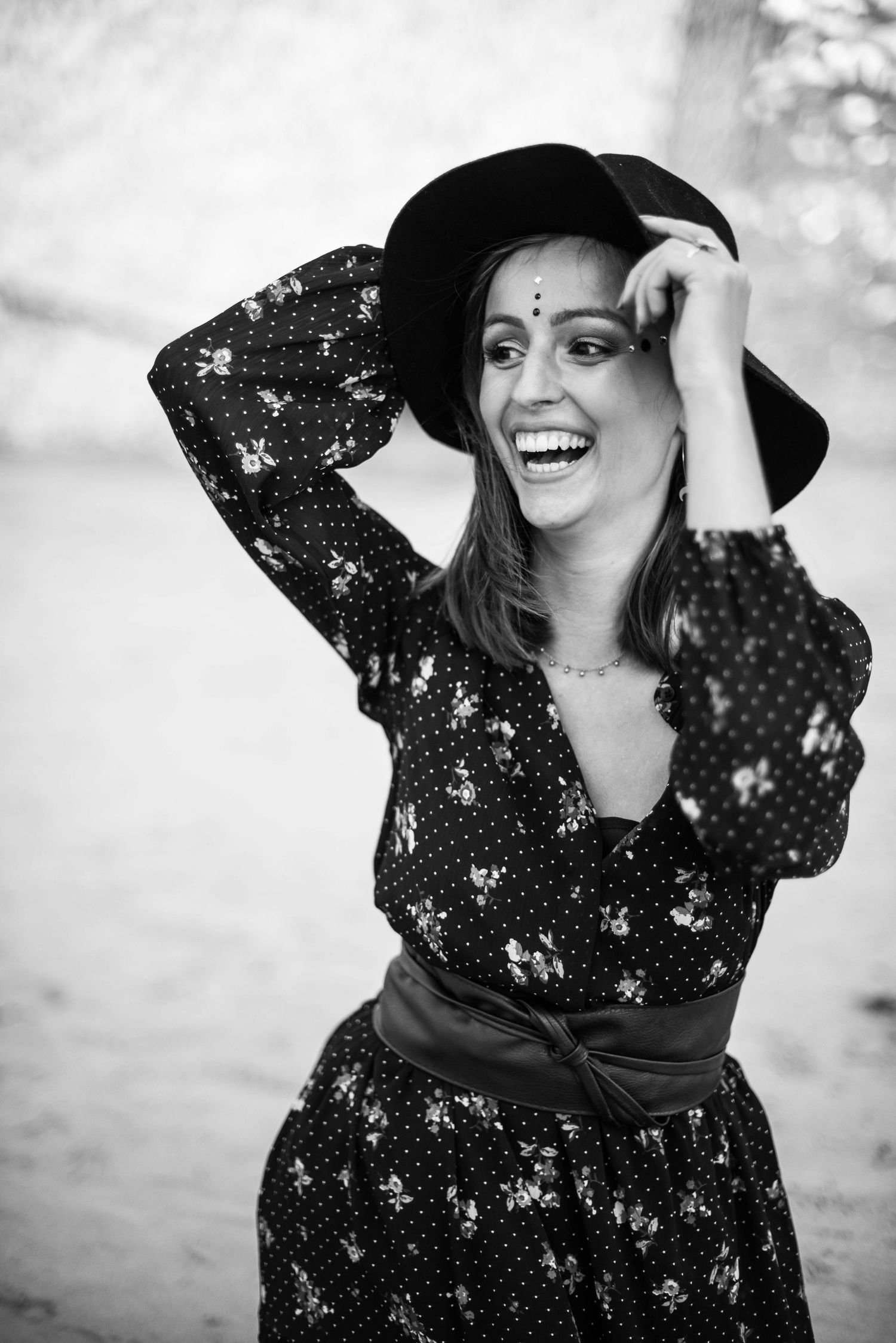 Black and white portrait series featuring a woman in a polka dot dress and wide-brimmed hat.