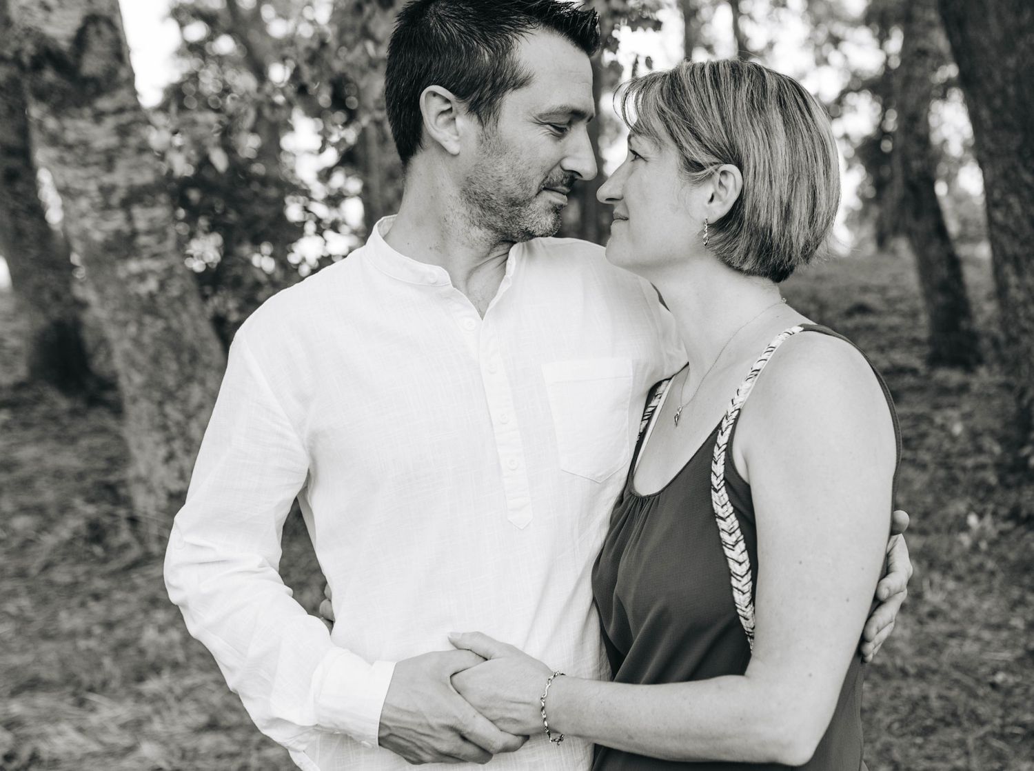 Black and white outdoor couple portraits showing tender embraces.