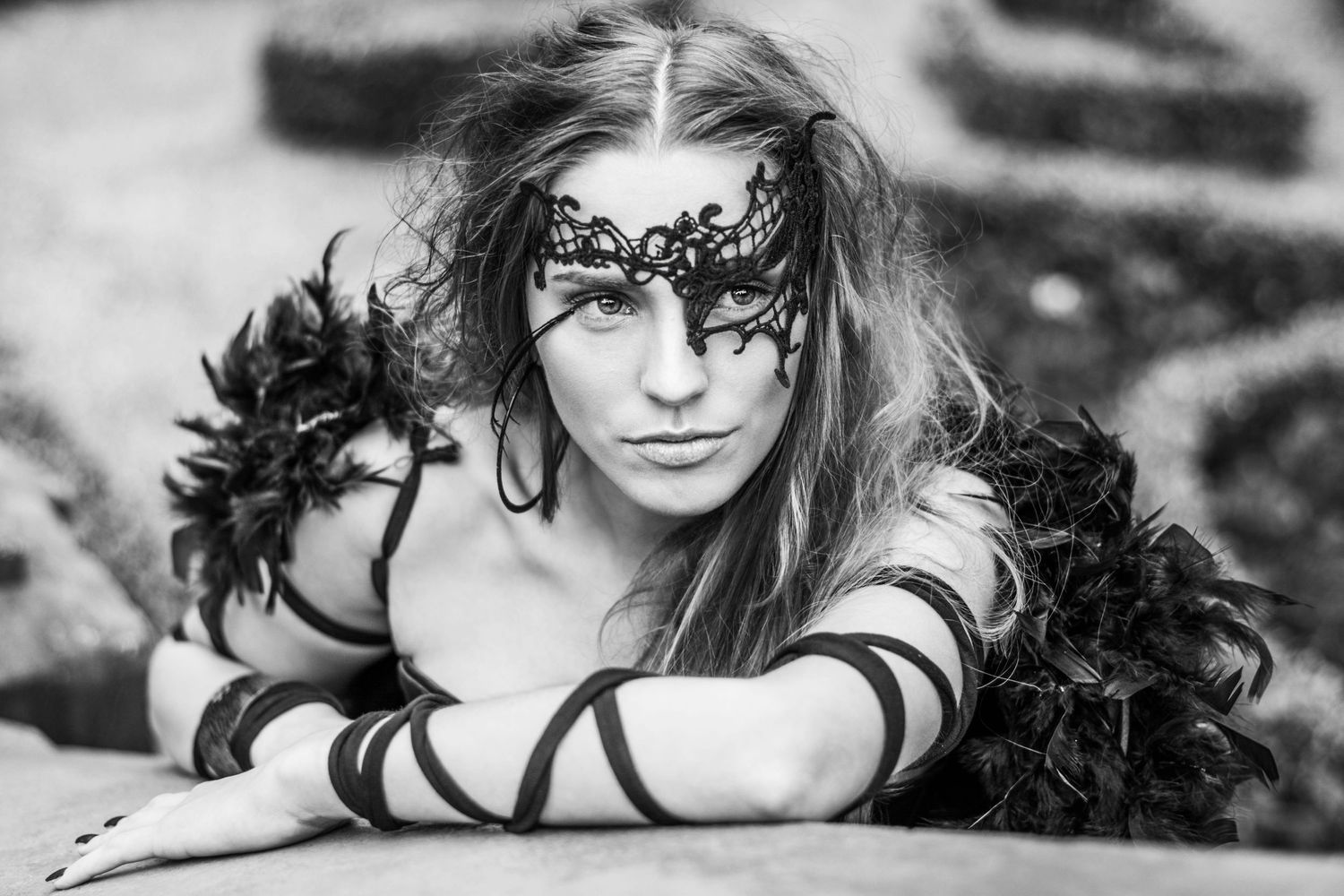 Dramatic black and white portrait series featuring intricate lace mask.