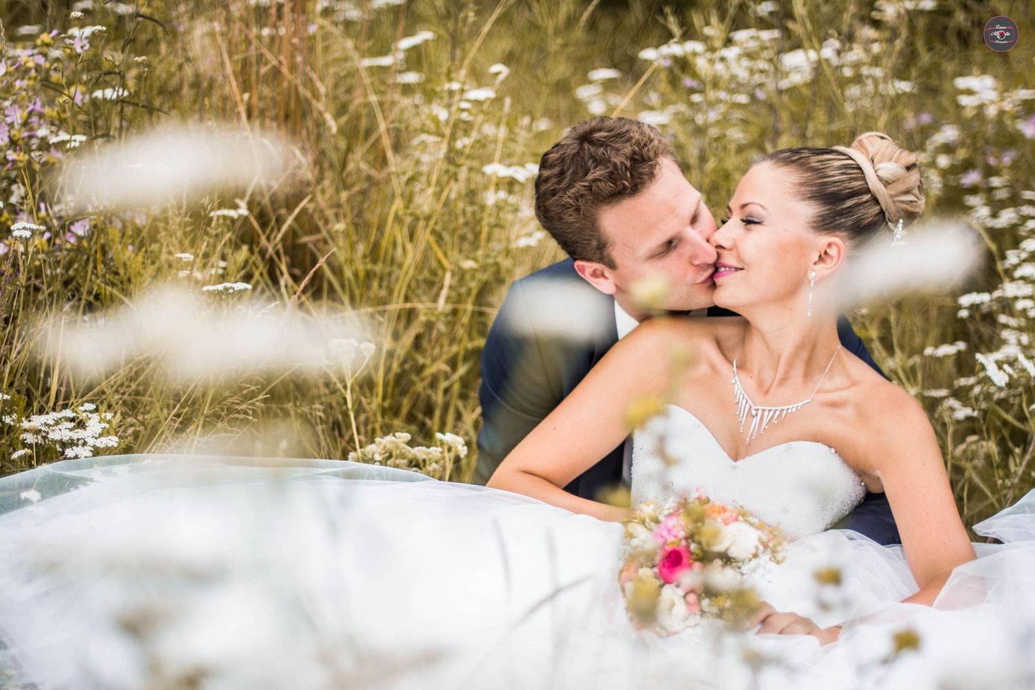 Romantic moment captured in a wildflower meadow during golden hour.