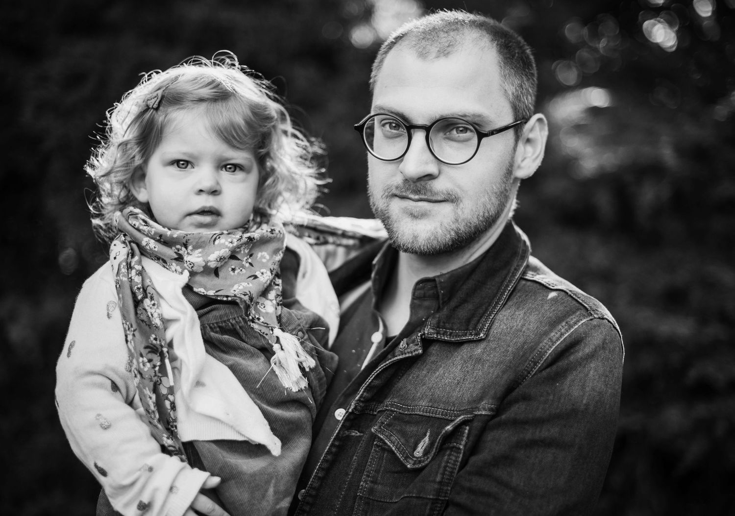 Black and white family portraits showing intimate moments outdoors.